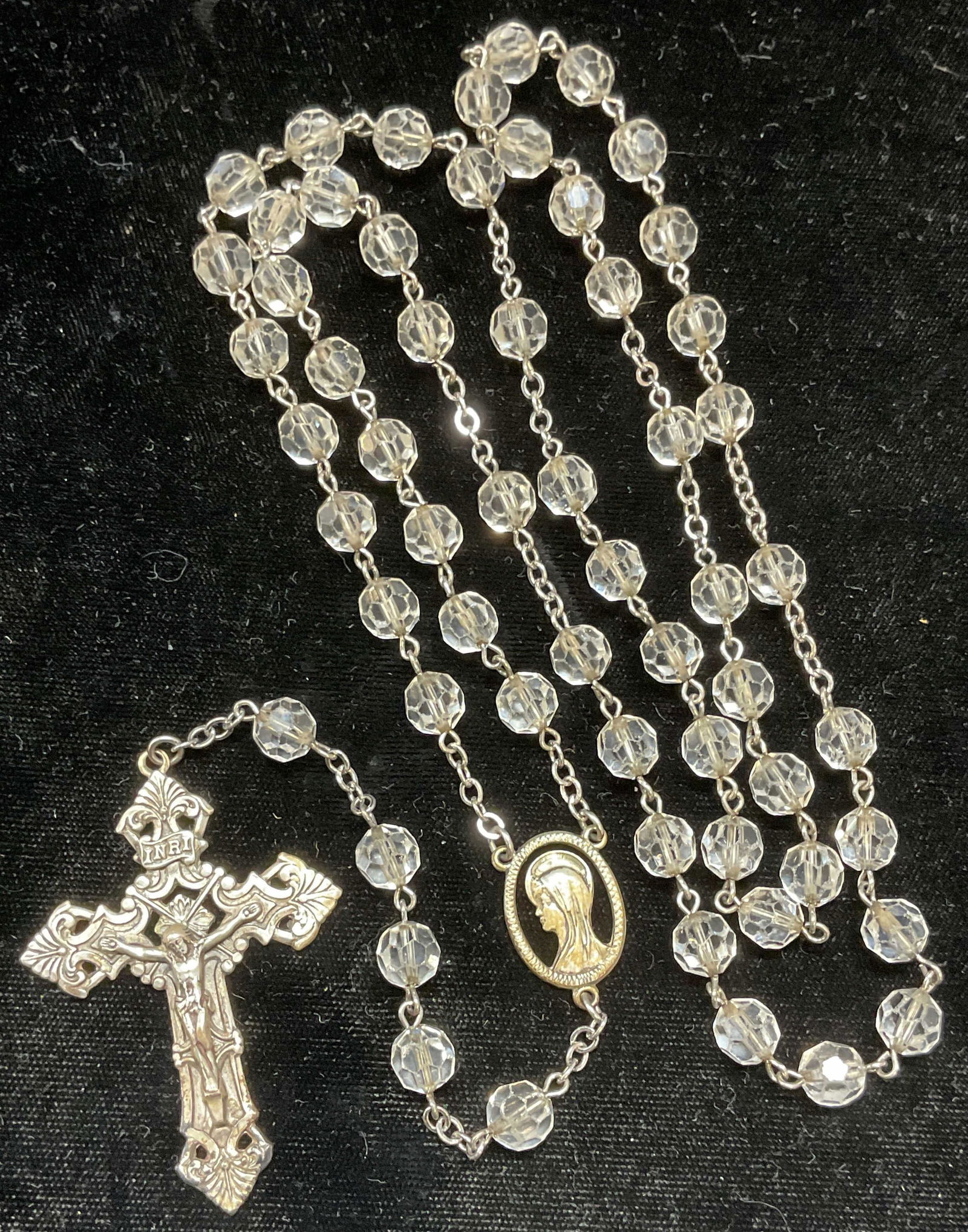 Sterling Silver & Crystal Rosary Beads Necklace: Colorless crystal rosary bead necklace with sterling silver pendants. Crucifix with image of Christ and Mary pendants. Marked sterling. Drop length approx 16 inches, total drop approx 23.5 inches. Som