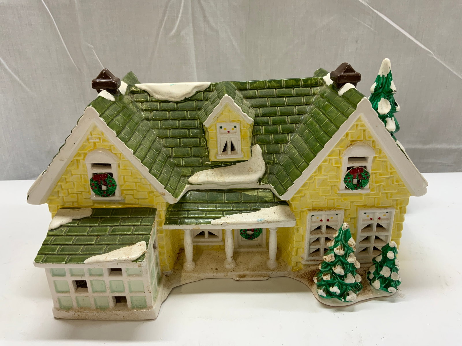 Dept 56 The Original Snow Village Ceramic 1993: Dept 56 The Original Snow Village Ceramic 1993 Ceramic yellow & green brick house w trees. Underside reads Dept 56 The Original "NANTUCKET RENOVATION" Snow Village 1993. Signed & marked. Surface wear 