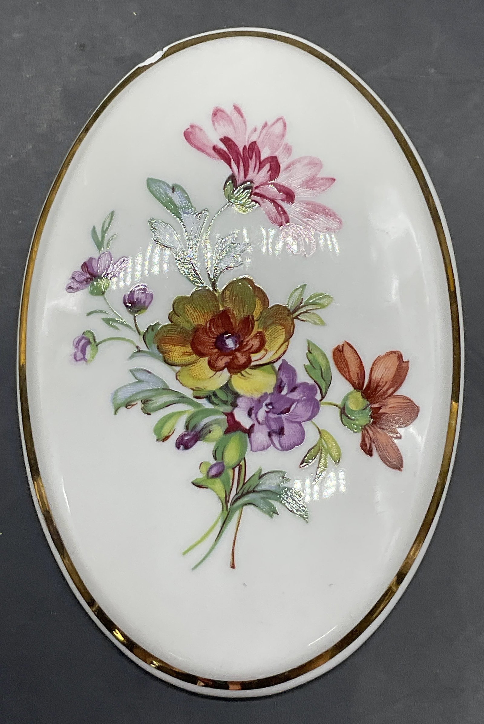 NPM MEISSEN GERMANY Floral Porcelain Wall Plaque: NPM MEISSEN GERMANY Floral Porcelain Wall Plaque. Oval form. Multicolored florals to the obverse. Metal hardware to reverse. Measures approx. 5L x 3.25W in. Underside signed NPM MADE IN MEISSEN/GERMAN