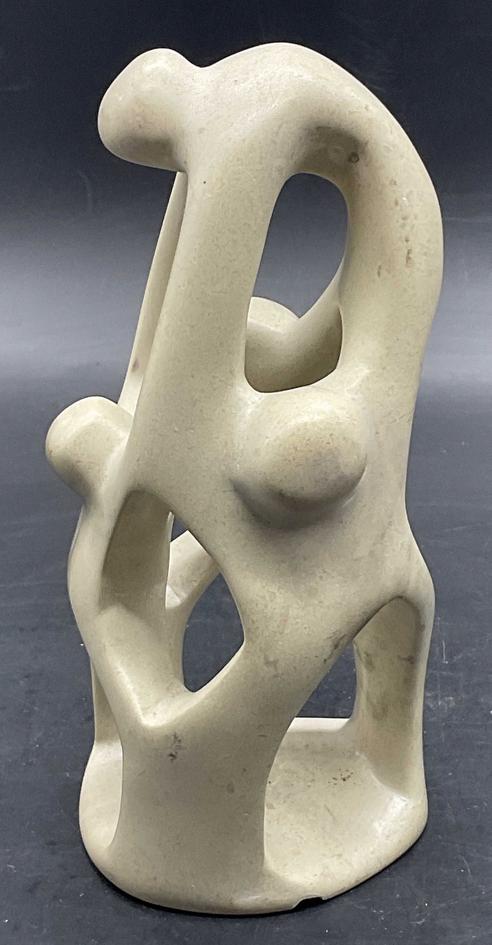 Carved Stone Family Figural: Carved Stone Family Figural. Depicts a group of figures melding into one another. Measures approx. 6H x 2.75W in. Chipping and surface wear present. home decor, home accents, homewares, housewares, ho