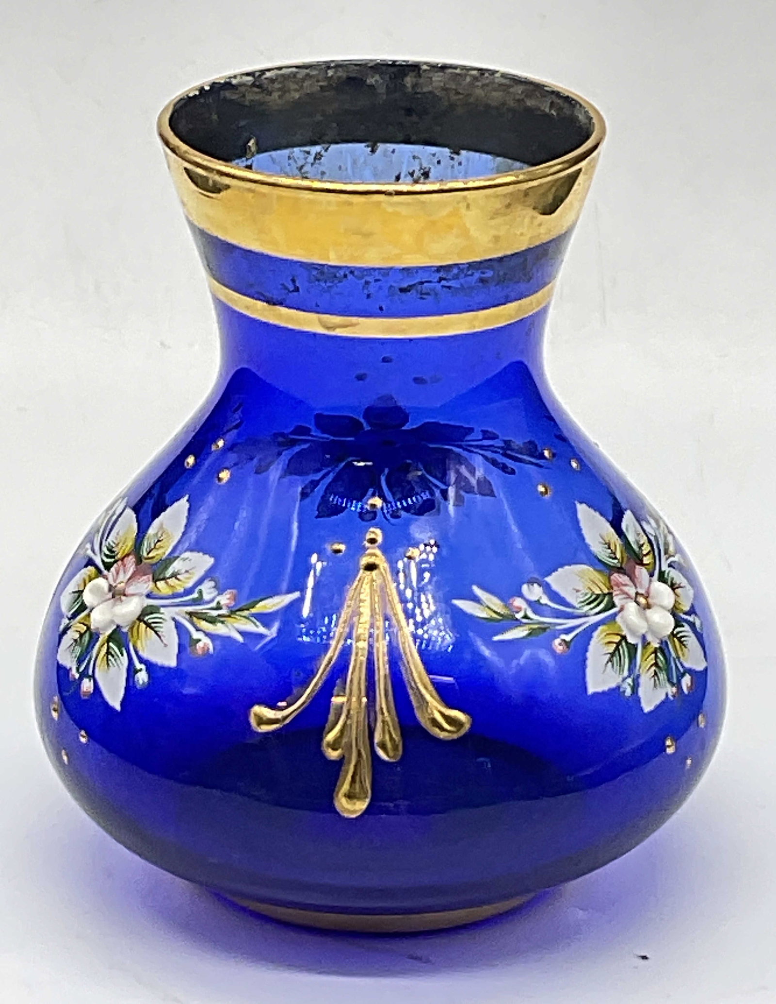 Vintage Hand Painted Cobalt Blue Art Glass Vase: Vintage Hand Painted Cobalt Blue Art Glass Vase. Raised florals and gilt line work to the piece. Measures approx. 4H x 3W in. Residue and surface wear present. Losses to paint. home decor, home accent