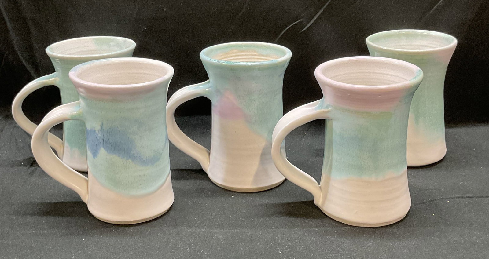 Set 5 Sgn KH Blue & White Art Pottery Cups: Set of 5 signed art pottery cups. Swirled glaze in blue and white. Signed on undersides KH. Measure approx 3 x 4.75 inches. Some wear to all including scratching. KH cup, KH mug, art pottery cult, cer