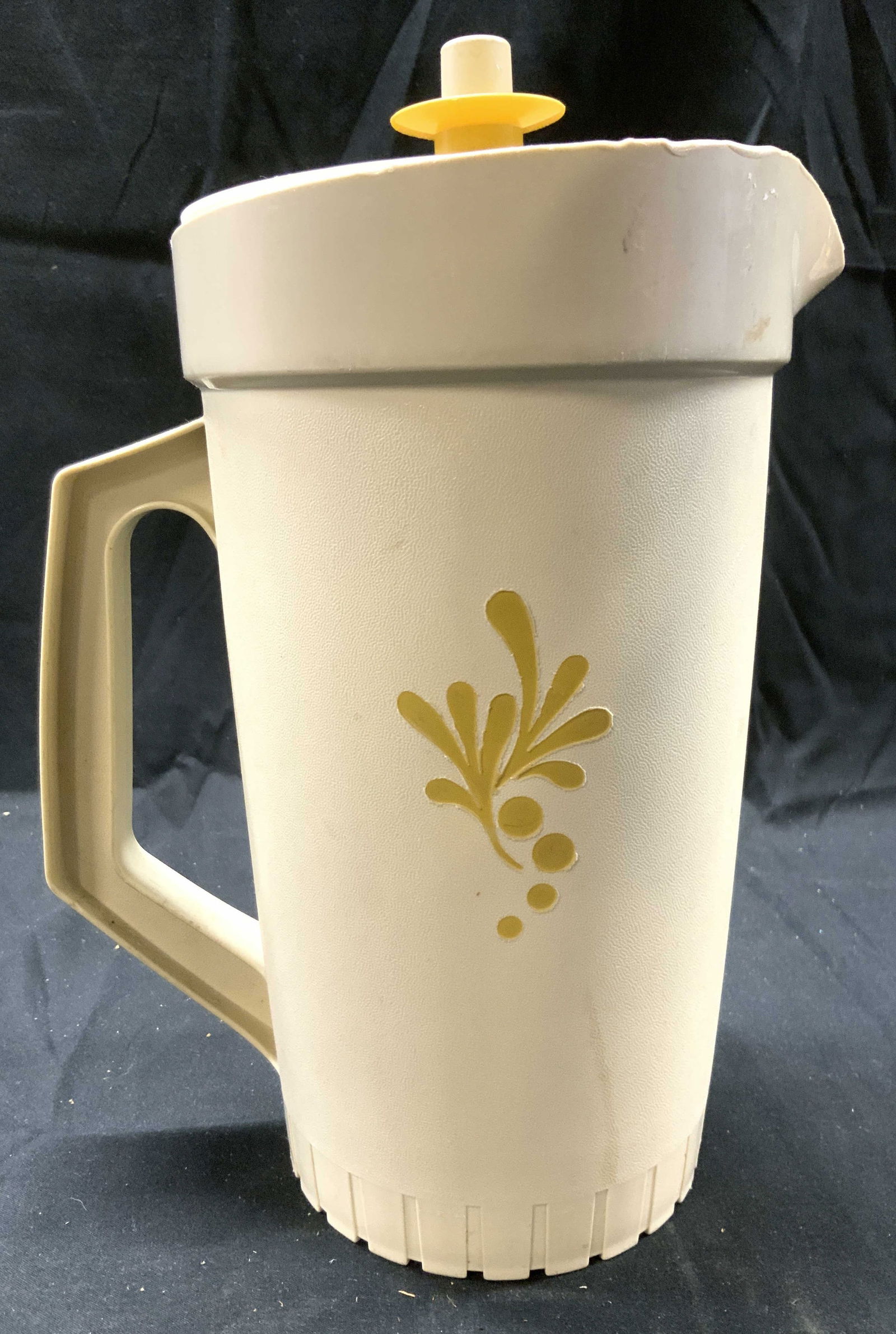 TUPPERWARE Vintage Plastic Pitcher W Lid USA: Underside is trademarked TUPPERWARE MADE IN USA. Pitcher is vintage. Piece includes lid. Pitcher has handle. Piece is tan with banana cream toned lid. Pitcher measures approximately 11 inches tall 7.5