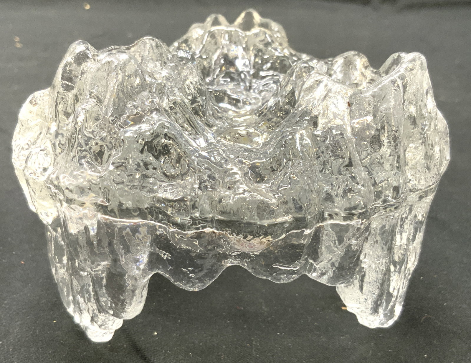 LE SMITH Crystal Ice Form Candle Holder: Tag on Underside reads LE SMITH. Candle holder has ice form. PIECE has 3 candle holding areas. Candle holder has 3 feet. Piece measures approximately 4.25 inches wide 3 inches tall. Candle holder, art