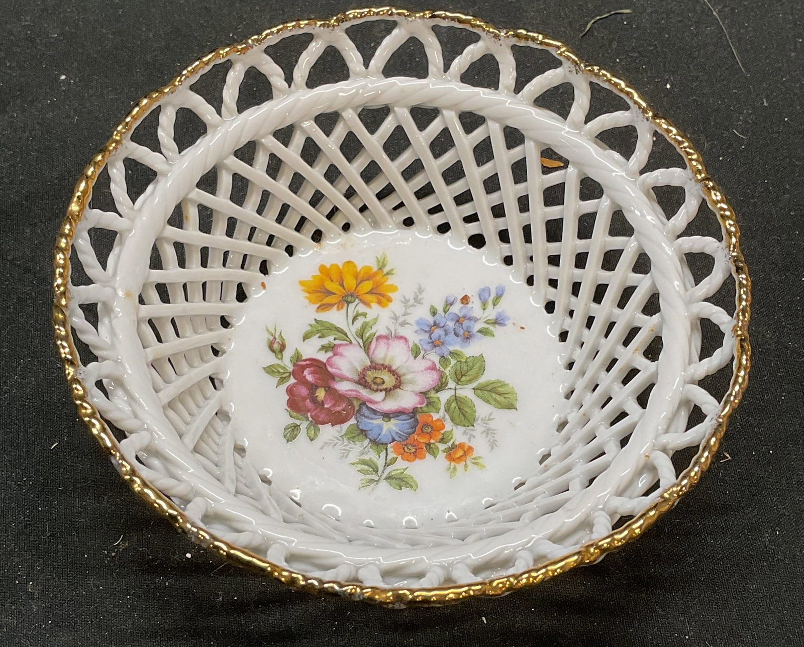 Vintage Iris Porcelain Floral Basket: Vintage Iris porcelain basket with floral motif and gilt rim. Signed on underside. Measures approx 4.25 x 1.75 inches. Some wear consistent with exposure. Iris porcelain, porcelain basket, floral bask