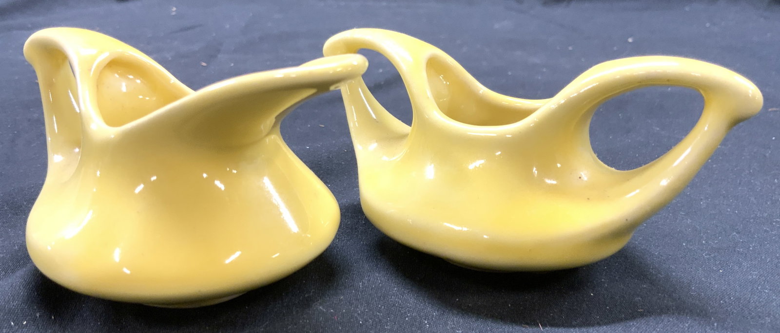 Set 2 Porcelain Cream & Sugar Dishes Yellow: Lot includes 1 creamer and 1 sugar dish. Each piece is yellow toned and porcelain. Each have handles. Sugar dish measures approximately 4 inches wide 2.5 inches deep 2 inches tall. Sugar dish, creamer