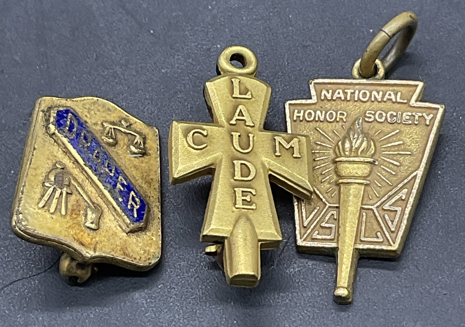 Lot 3 Gold Filled Pendant & Gold Tn Metal Pins: Three vintage gold tone metal and gold filled pins and pendant. The pendant features a torch motif and is marked 8 GF to the reverse. The pendant measures approx. 1L x .5W in. Some read Cum Laude, Nat