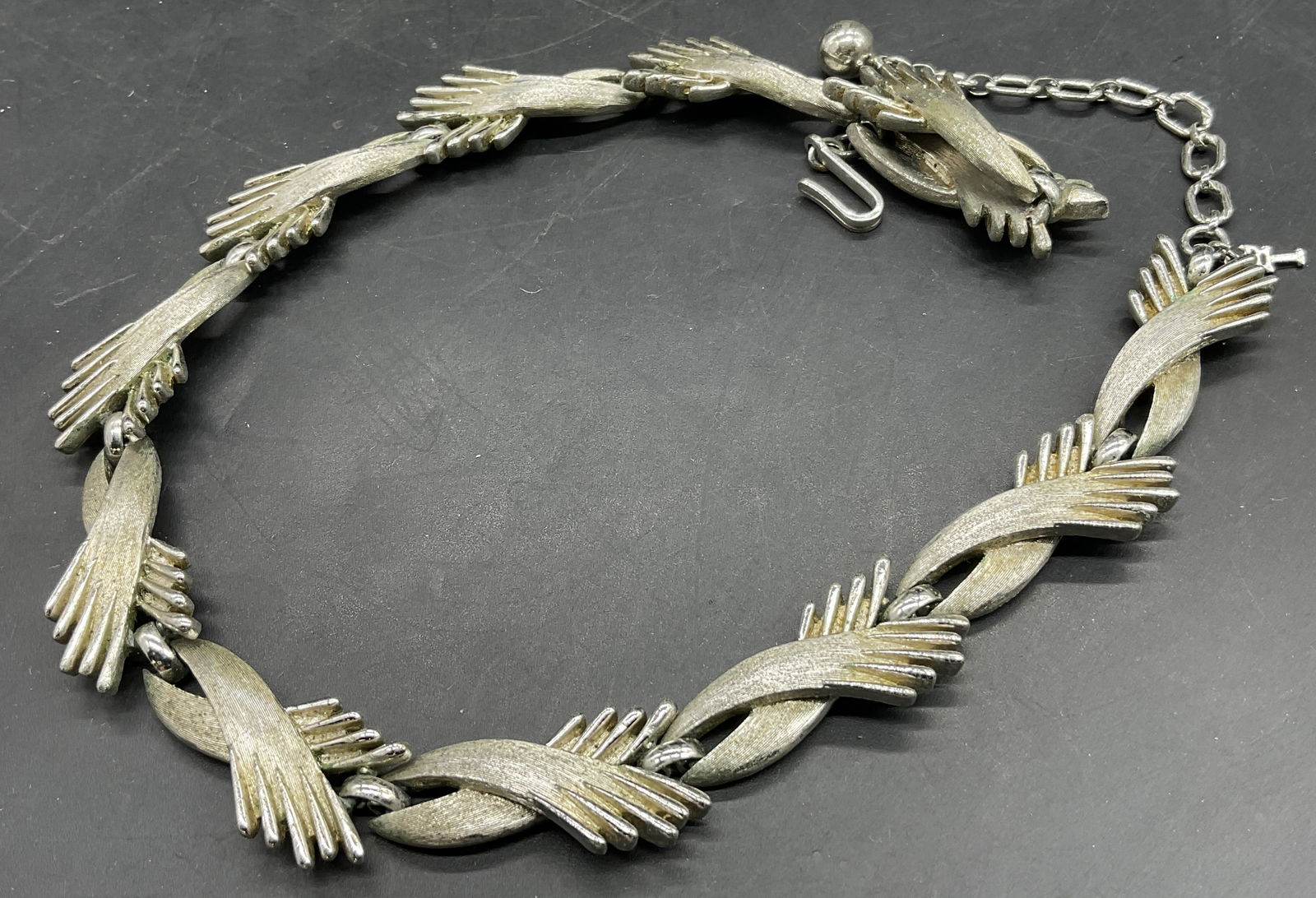 TRIFARI Vintage Geometric Motif Choker Necklace: TRIFARI Vintage Geometric Motif Choker Necklace. Crafted from silver tone metal. Adjustable length. Fishhook clasp closure marked TRIFARI. Necklace length measured end to end approx. 16 inches. Surfac