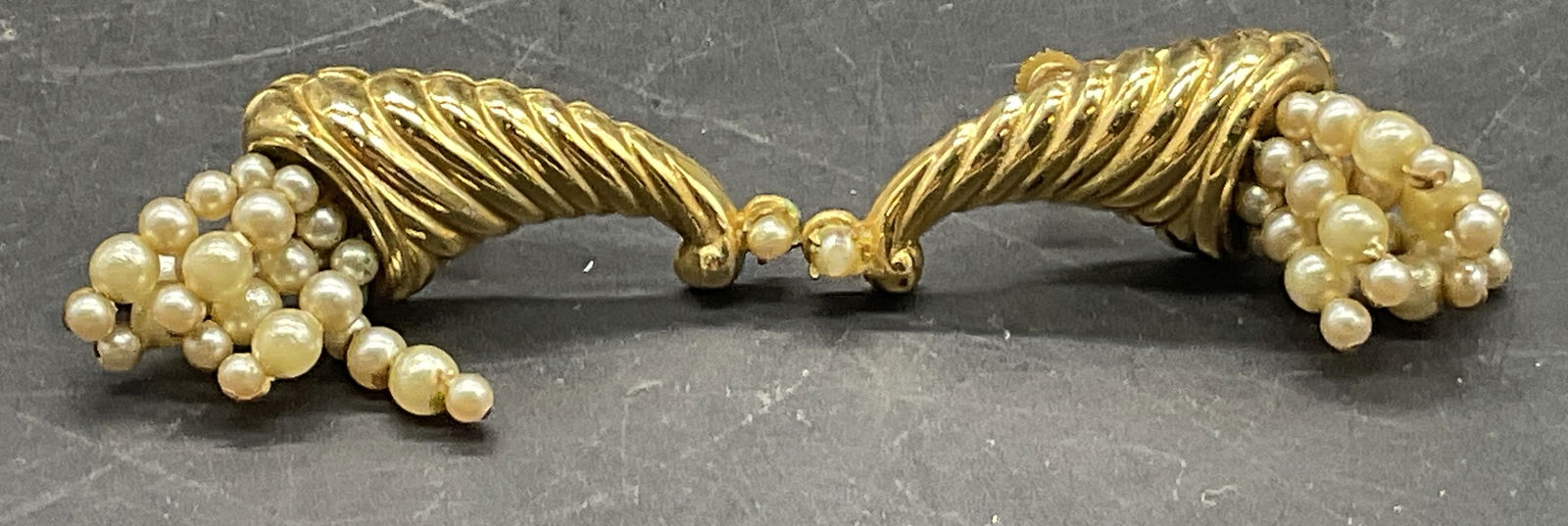 CORO Vintage Pearlescent Bead Cornucopia Earrings: CORO Vintage Pearlescent Bead Cornucopia Earrings. Crafted from gold tone metal and pearlescent beads. Screw backings. Measures approx. 1.5L x .5W in. Discoloration, residue, surface wear, and warping