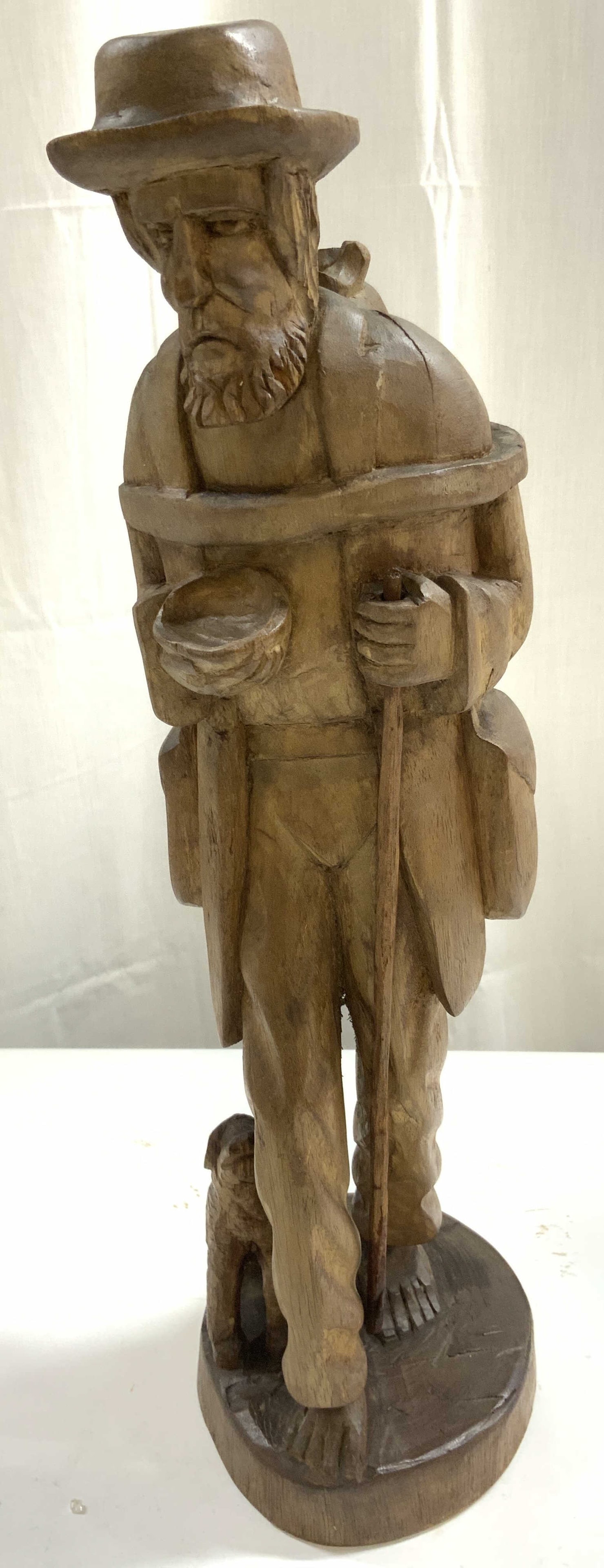 Carved Wooden Tramp Art Male Hobo & Dog Figure: Carving is vintage and wooden. Piece is Light brown toned possibly carved by hand. Depicts a male hobo figure standing next to a seated dog. Vintage tramp art wood carving. Piece measures approximatel