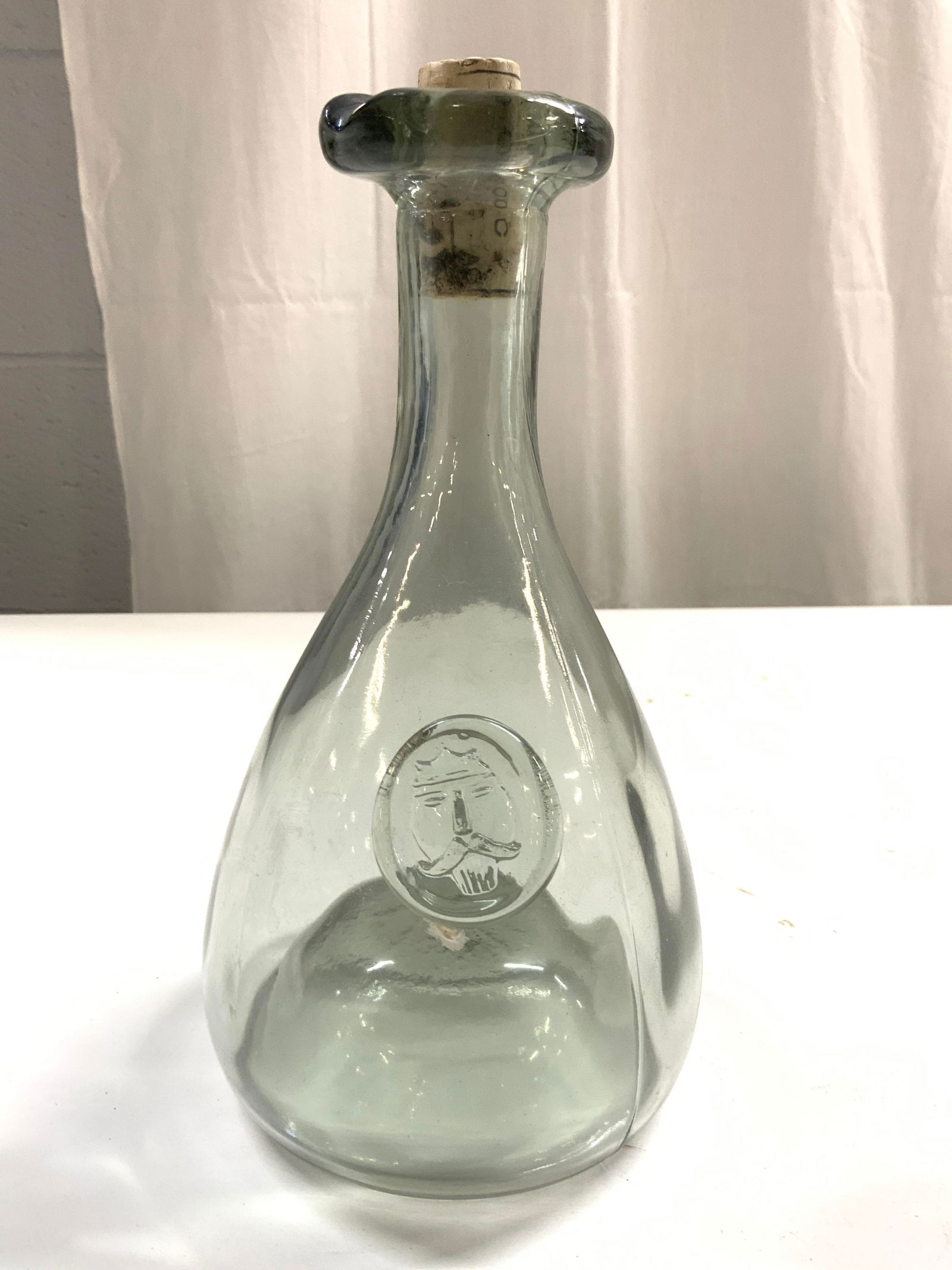 HOLMEGAARD Vtg H blown Art Gls Decanter W Cork: Decanter appears to be HOLMEGAARD DENMARK. Stopper Decanter is vintage. Piece appears to be hand blown. Piece has molded glass medallion detail with facial image. Decanter includes cork stopper. Under