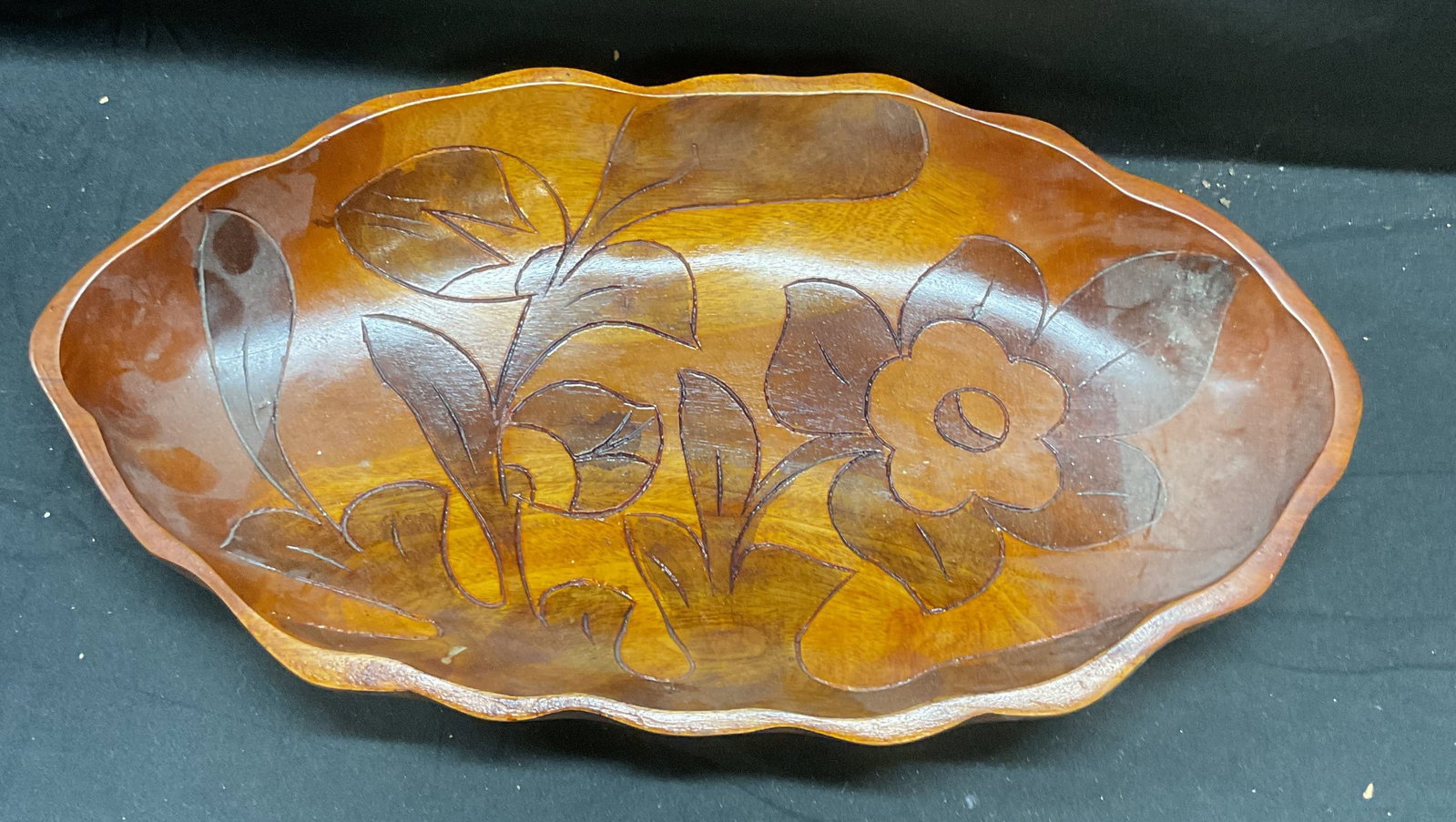 Vintage Carved Wood Floral Bowl: Vintage carved wood floral pattern wood bowl. Measures approx 15.5 x 8 x 2.25 inches. Some scratching observed. Bowl, wood bowl, carved wood bowl, floral bowl, tableware, table decor, table accessorie