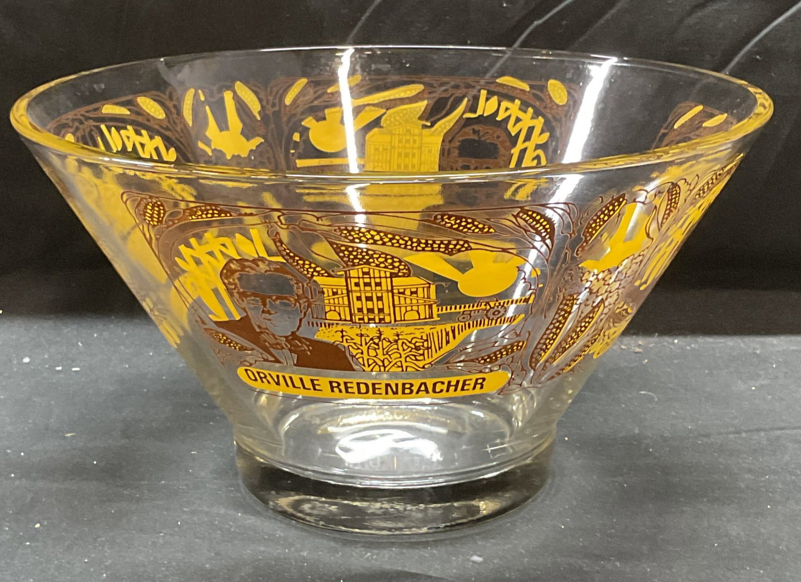 Glass Orville Redenbacher Popcorn Bowl: Glass bowl. Orville Redenbacher graphic motif with portrait, corn, and building. Measures approx 10.5 x 6 inches. Some scratching observed. Orville Redenbacher, bowl, glass bowl, popcorn bowl, tablewa