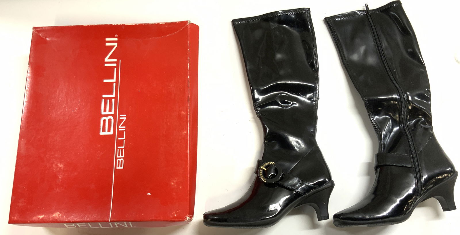 BELLINI WAKEUP Pat Leath Knee High Heel Boots 7 Bx: Box reads BELLINI STYLE WAKE-UP SIZE 7M. Boots are black toned patent leather. Boots each have zipper. Heel is 2 inches high. Includes original box. Box is red with white text. Boots measure approxima