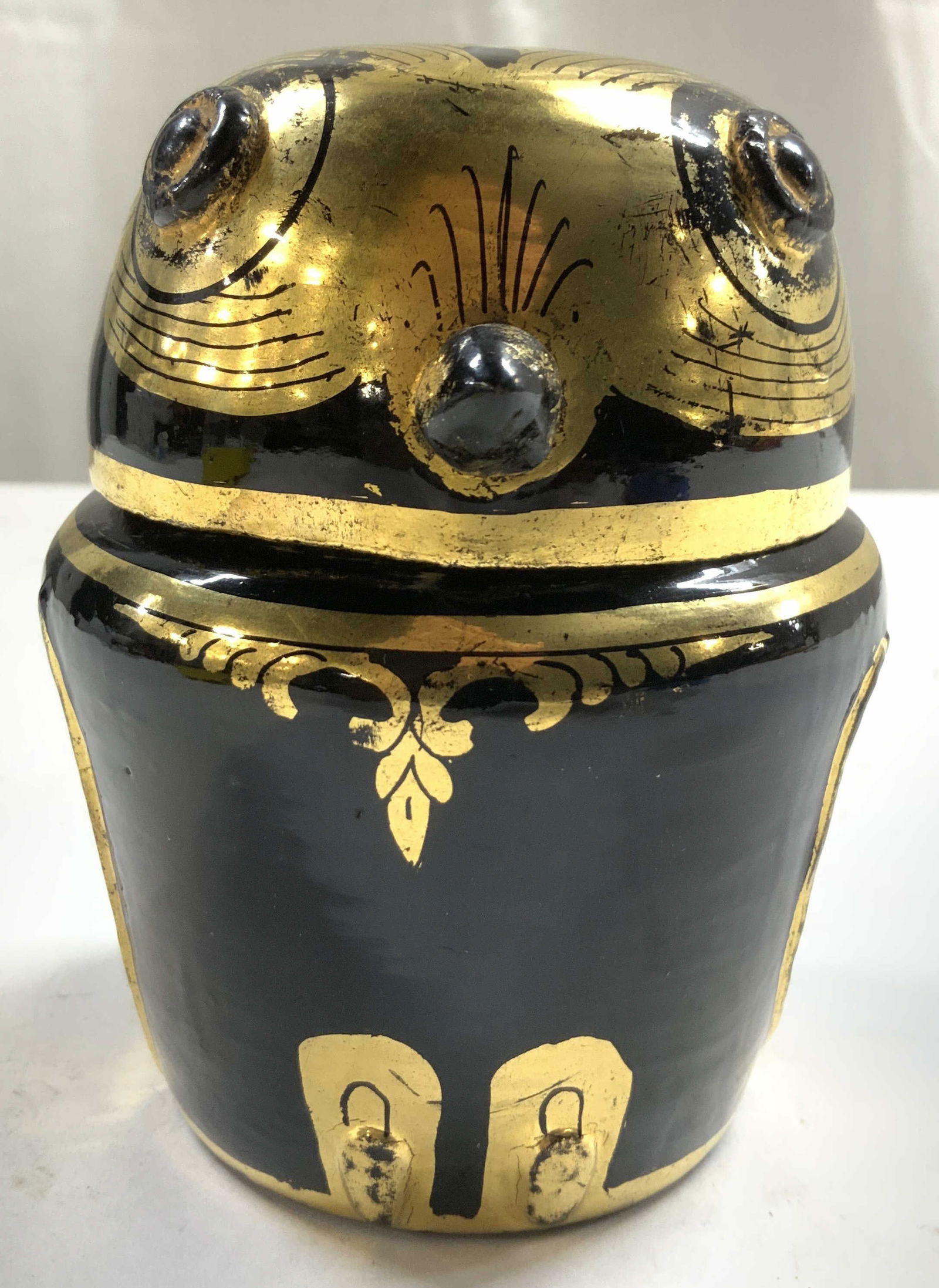 Lacquer & Gilt Owl Form Urn W Lid: Urn is black toned lacquer and gilt. Piece has owl form. Urn includes lid. Piece has gilt facial and wing detail. Vessel with lid measures approximately 4.5 inches tall 3.5 inches wide. Urn, vessel, u