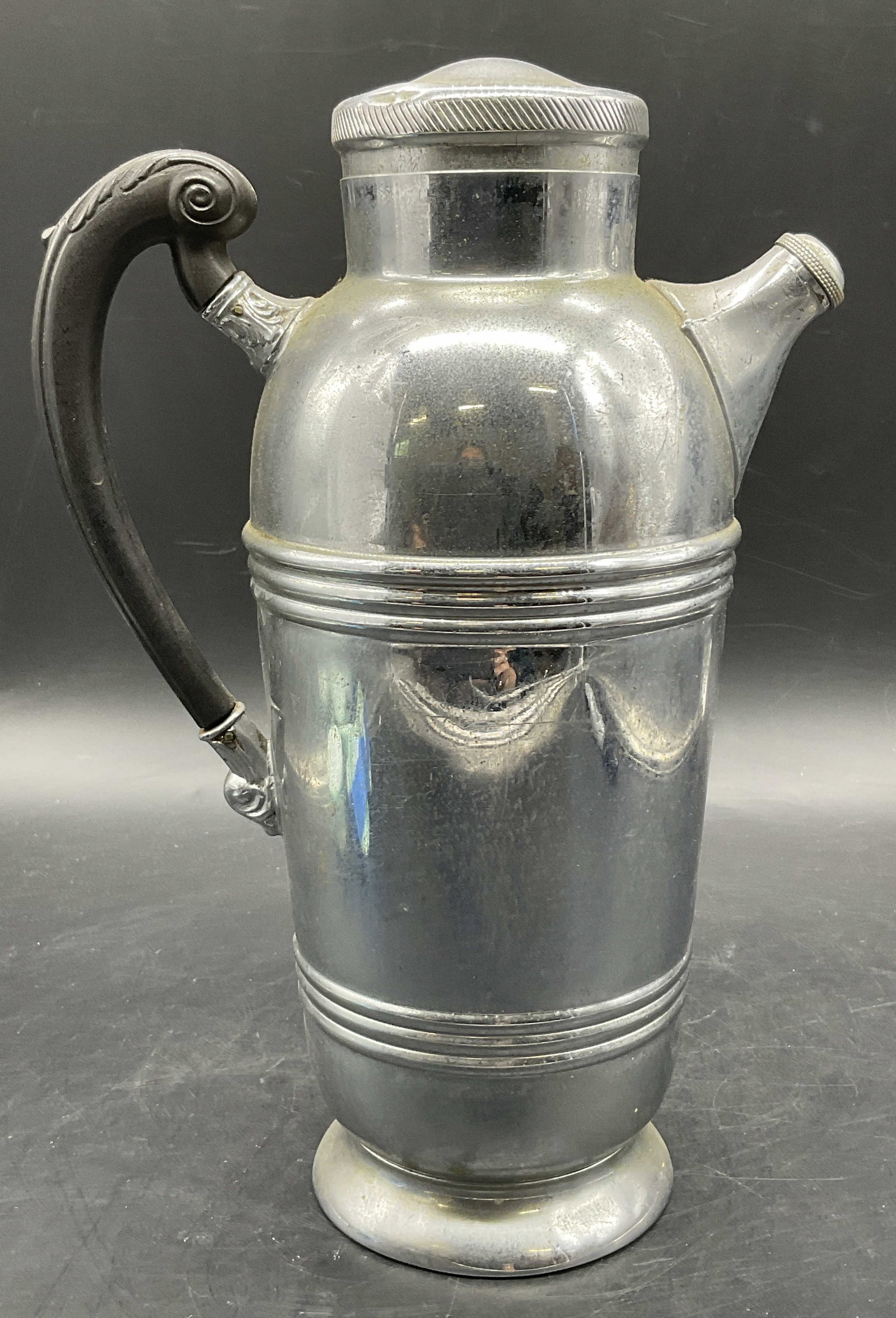 KROME KRAFT FARBER BROS Cocktail Shaker, Lid: Vintage KROME KRAFT FARBER BROS Cocktail Shaker. Lidded. Silver tone chrome body with a black handle. Measures approx. 10.5H x 7W in. Underside reads KROME KRAFT FARBER BROS. Residue, discoloration, s