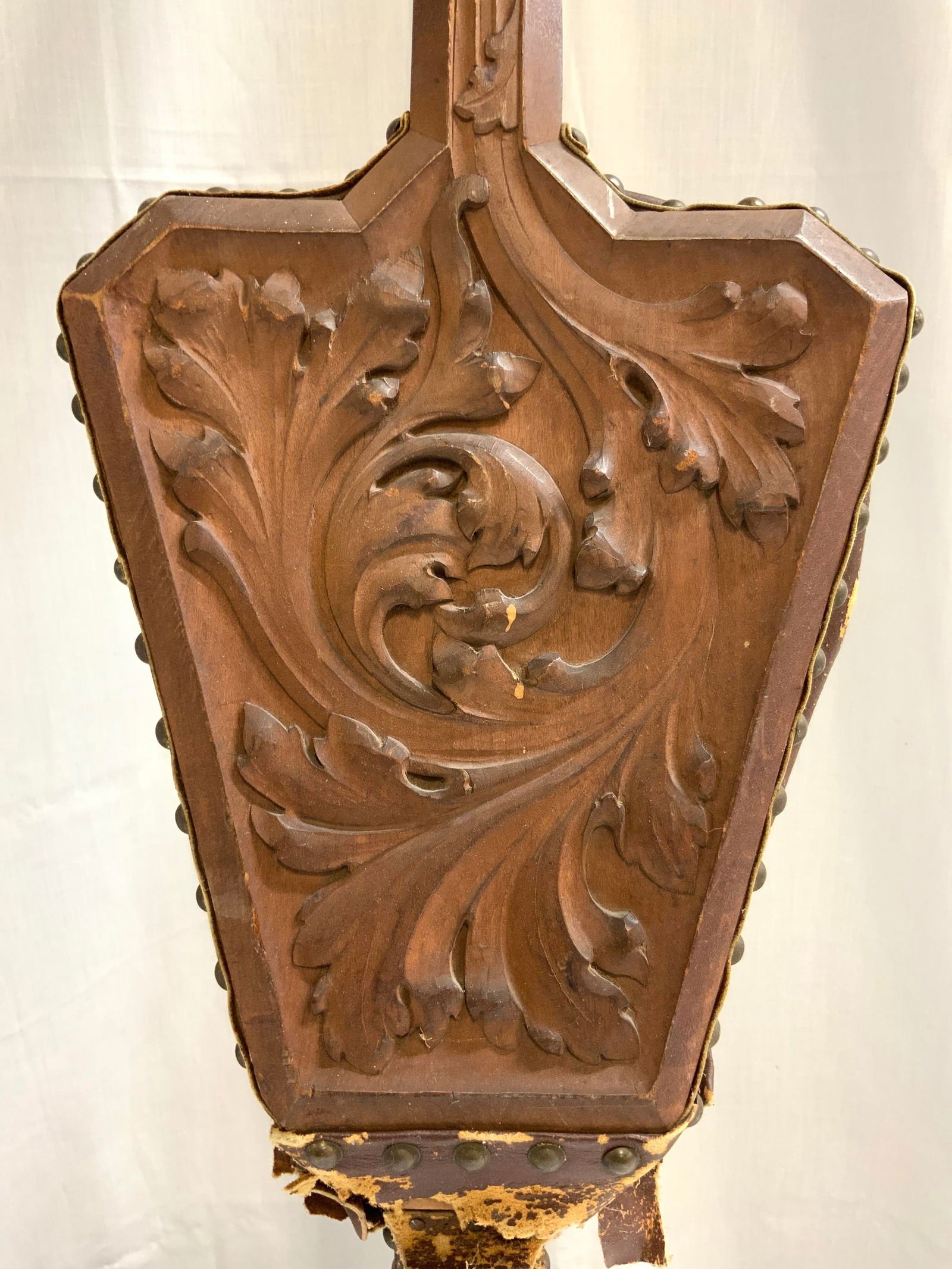 Vintage Carved Wood & Leather Fireplace Bellow: Fireplace bellow is vintage. Piece is wooden with carved scroll and leaf detail. Bellow area is brown toned appears to be leather with gilt metal nailhead detail at edges. Piece has gilt metal nozzle