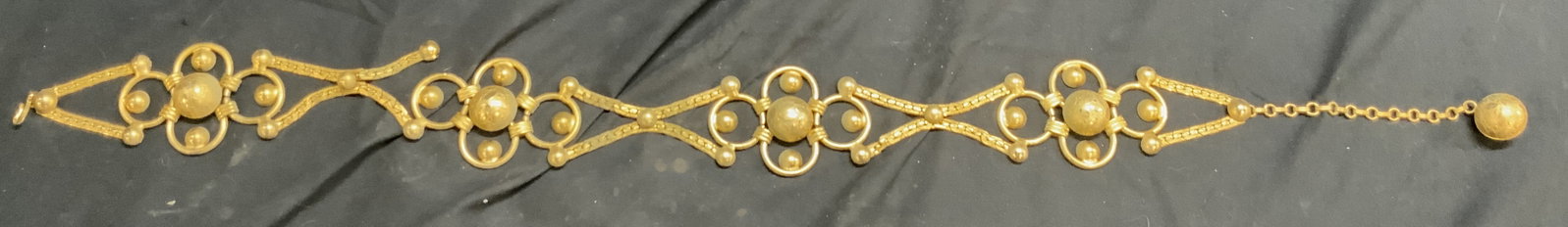 Art Deco Gilt Metal Link Belt: Belt is gold toned gilt metal. Piece has art deco style. Belt has link structure. Piece has hook at one end & spherical structure on other end. Belt measures approximately 33 inches long 2.25 inches w