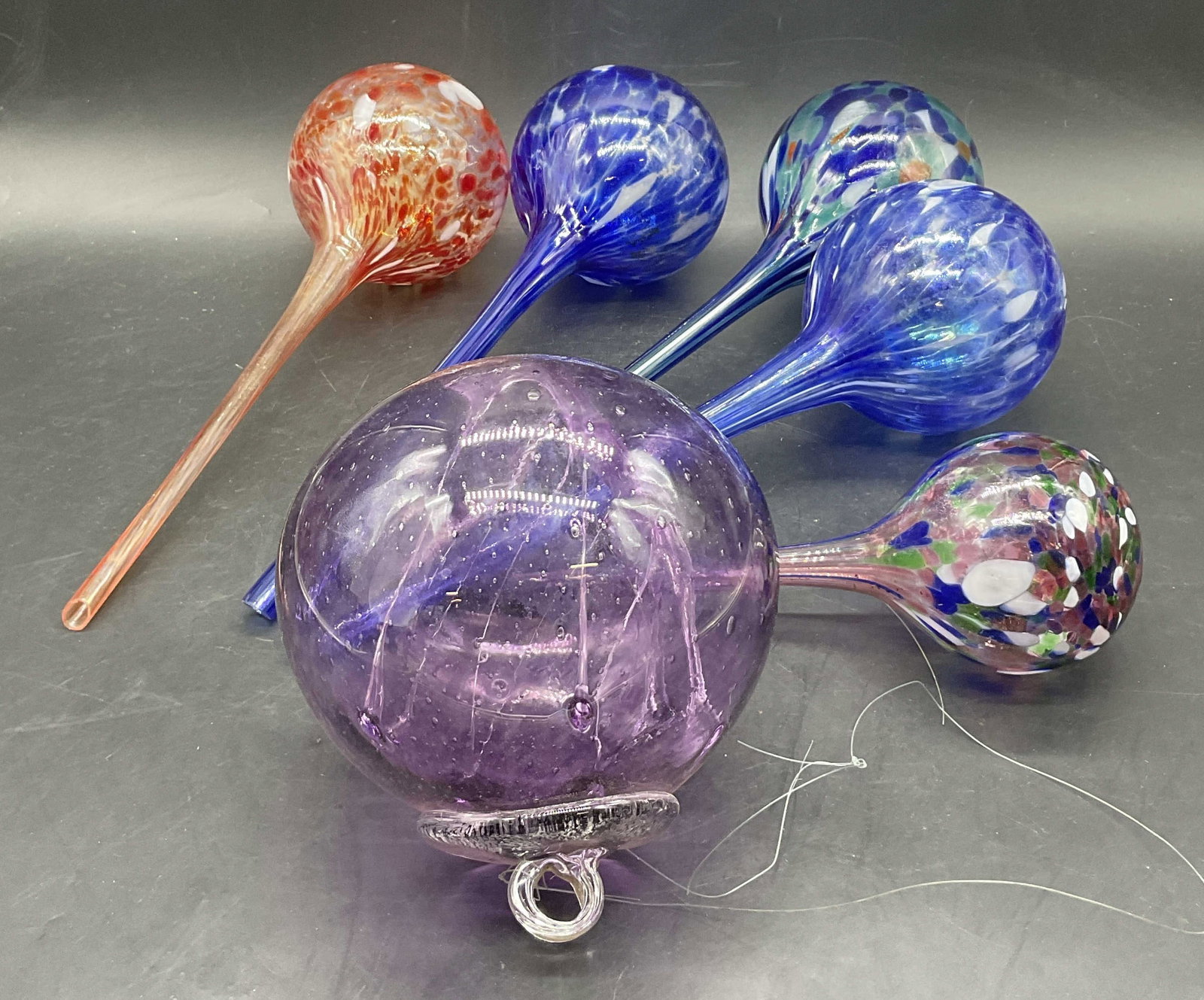 Lot 6 Art Glass Water Globes & Hanging Ornament: Five Art Glass Water Globes & One Hanging Ornament. Longest measures approx. 11L x 3.25W in. Chipping, surface wear, residue, and bubbles to glass present. home decor, home accents, homewares, housewa