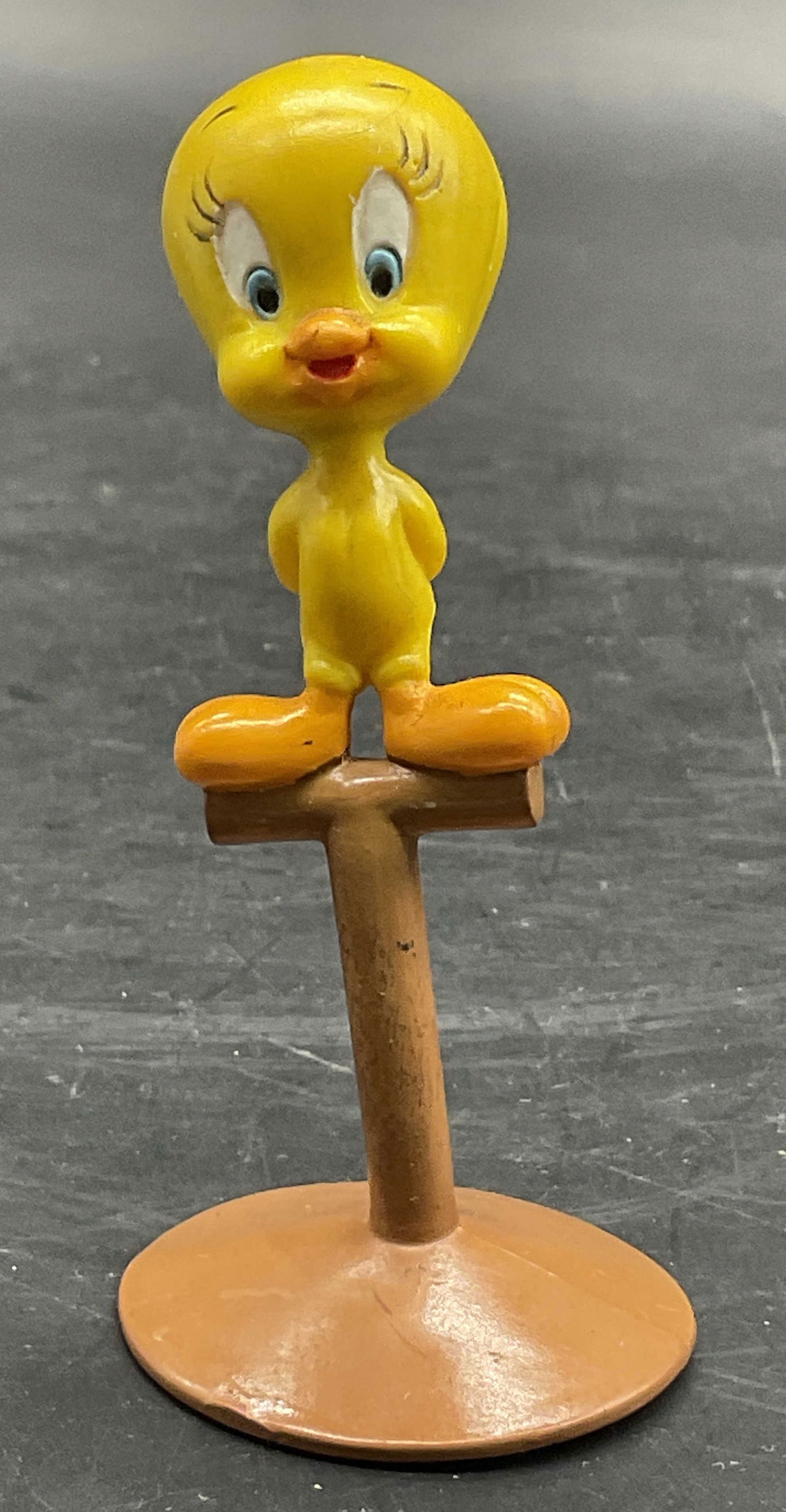 1988 APPLAUSE Tweety Bird Figural / Toy: 1988 APPLAUSE Tweety Bird Figural / Toy. Crafted from resinous or plastic materials. Measures approx. 3H x 1.5W in. Underside reads 1988 APPLAUSE. Warping to the piece. Surface wear consistent with ag