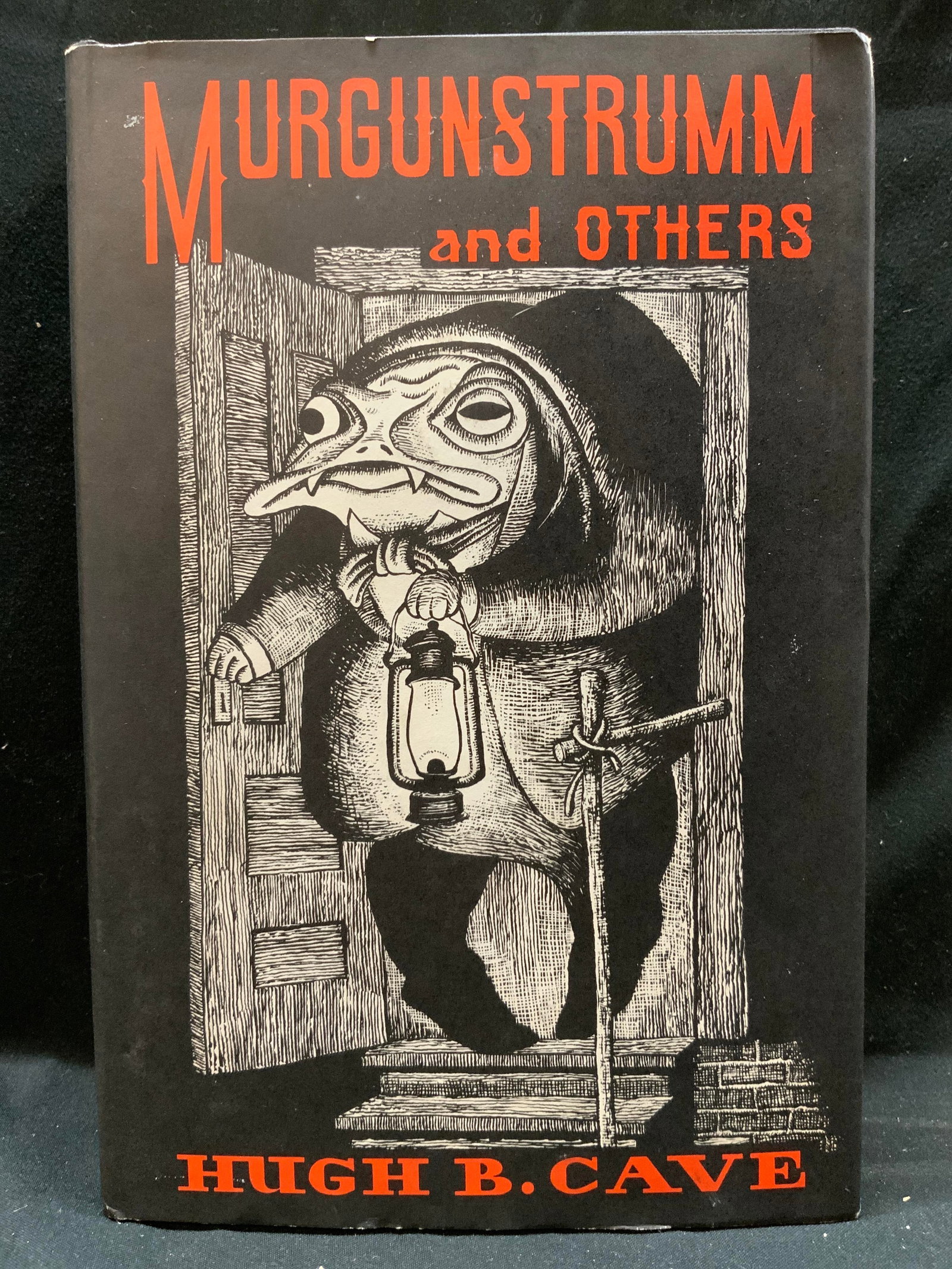 Murgunstrumm & Others Illustr. First Edition 1977: Murgunstrumm & Others Illustr. First Edition 1977Horror book by Hugh B. Cave. Published in 1977. Front cover has illustrations of a creature holding a lantern. Title is in red bold letters. Surface we