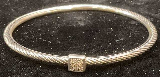 David Yurman Sterling Silver Diamond Bracelet: David Yurman sterling silver bangle bracelet with cable band and diamond accents. Signed DY. Marked sterling. Measures approx 2.25 inches wide. Total weight 12.9 grams. Some wear including scratching