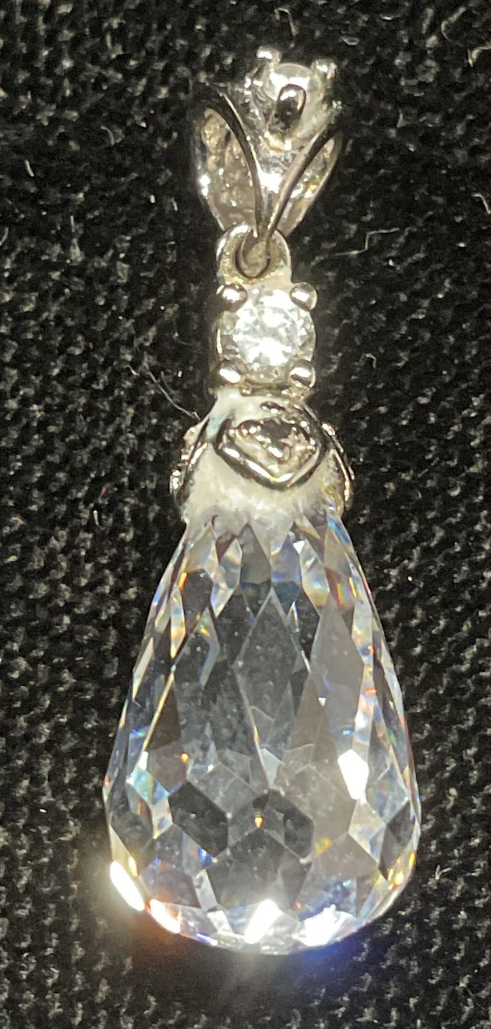 Swarovski Sterling Silver Crystal Pendant: Swarovski sterling silver pendant with faceted cut crystal drop pendant and cubic zirconia accents. Signed and marked sterling. Measures approx 7/8 inches long. Total weight 2.9 grams. Some wear inclu
