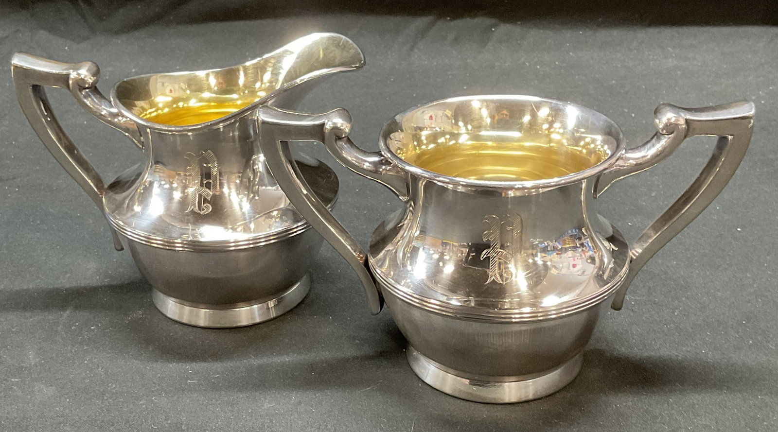 Poole Co Silver Plated Creamer & Sugar Bowl: Poole Silver Co silver plated creamer and sugar bowl set. Engraved monogram P. Signed on undersides. Creamer measures approx 5,25 x 3.75 x 4.25 inches. Sugar bowl measures approx 6.5 x 3.75 x 3.75 inc