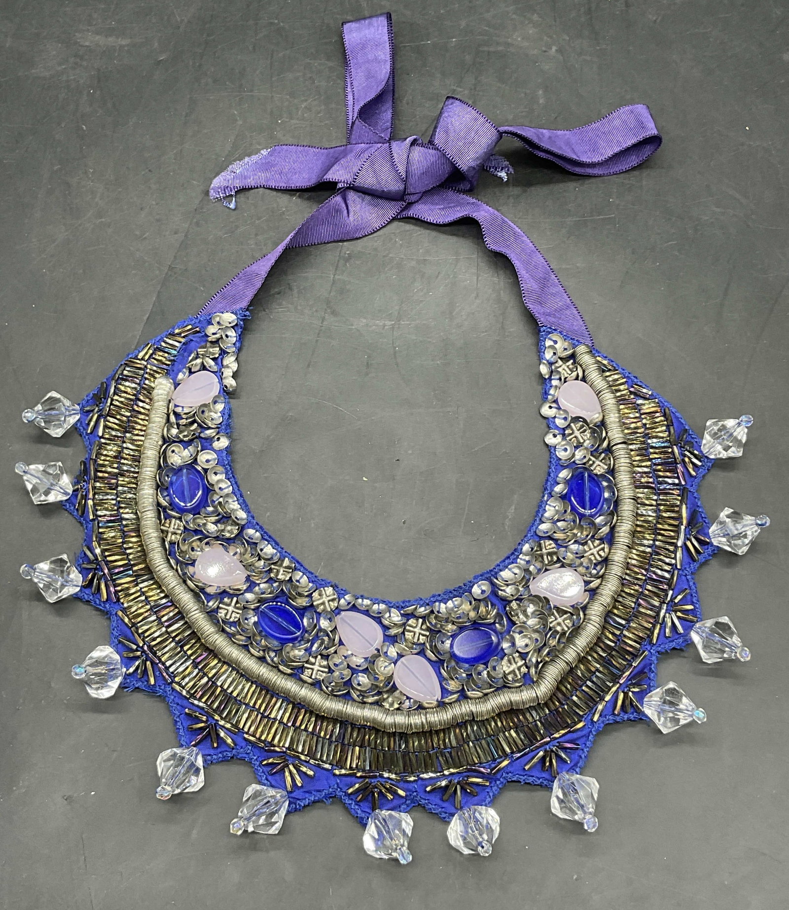 ROBERTA FREYMANN by OLIVIA PALERMO Bib Necklace: ROBERTA FREYMANN Bejeweled Fabric Bib Necklace. Tag to reverse reads ROBERTA FREYMANN by OLIVIA PALERMO. Necklace length measured end to end approx. 41 inches. Tie on, adjustable length. It features a