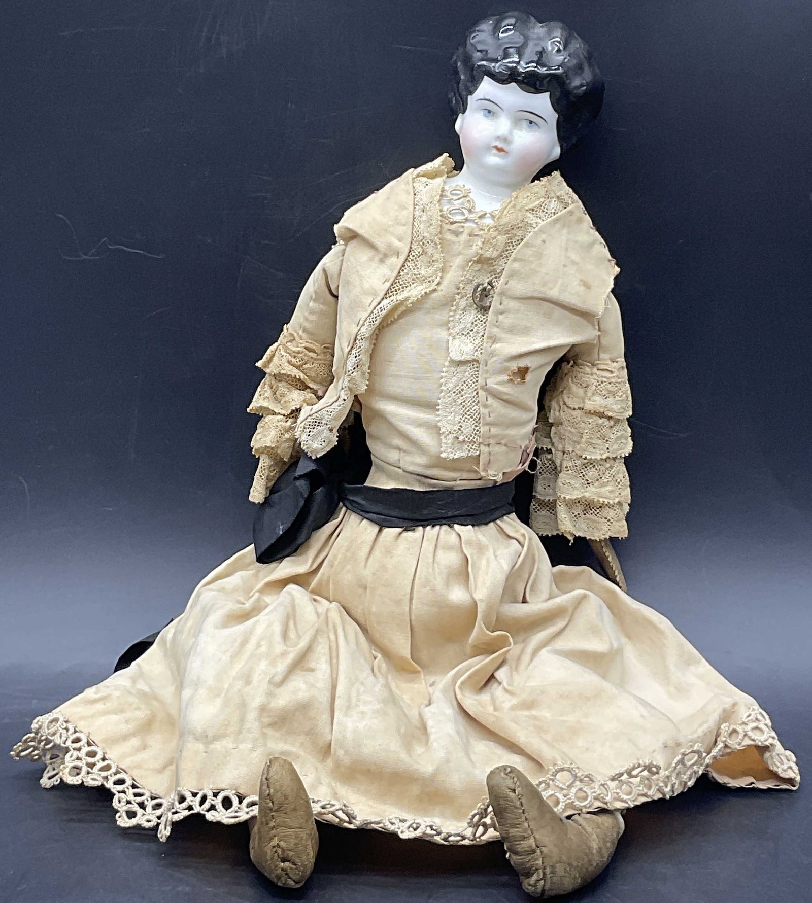 Vntg Porcelain Doll Head W/ Handmade Fabric Body: Vintage Porcelain Doll Head With Handmade Fabric Body. Hand painted details to the face. Measures approx. 14L x 4W in. Losses, discoloration, and surface wear present. home decor, home accents, homewa