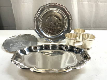 Lot 6 Silv Pl Pewter & Brushed Metal Tabletop Accs: Lot includes 1 Footed silver plated tray inscribed ENGLISH SILVER MFG CO BY FONARD SILVER, 3 silver plate cups, 1 brushed metal tray with floral detail, & 1 RWP Pewter plate which reads NEW YORK UNIVE