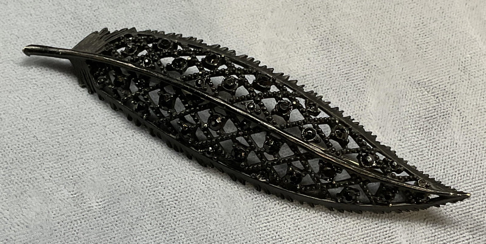 Vintage Black Crystal Feather Brooch: Vintage black feather motif brooch with crystal. Measures approx 3.75 x 1 inches. Some wear including scratching observed. Jewelry, estate jewelry, costume jewelry, cocktail jewelry, fashion jewelry, 