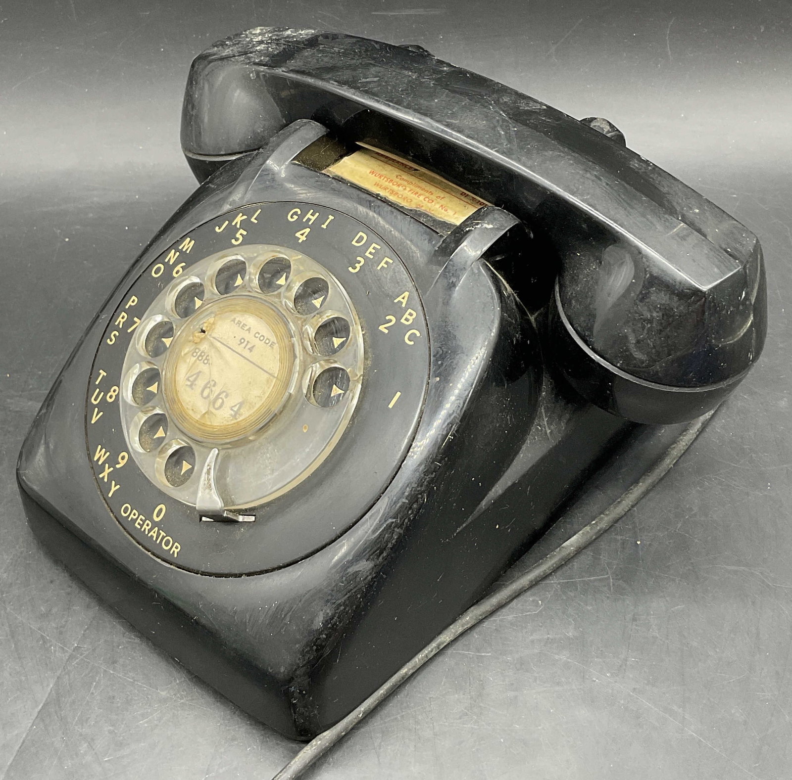 Vintage Black Rotary Telephone: Vintage Black Rotary Telephone. Crafted from metal and hard plastic material. Measures approx. 4.25H x 8W in. Not tested for function. Cracking, surface wear, and losses present. home decor, home acce