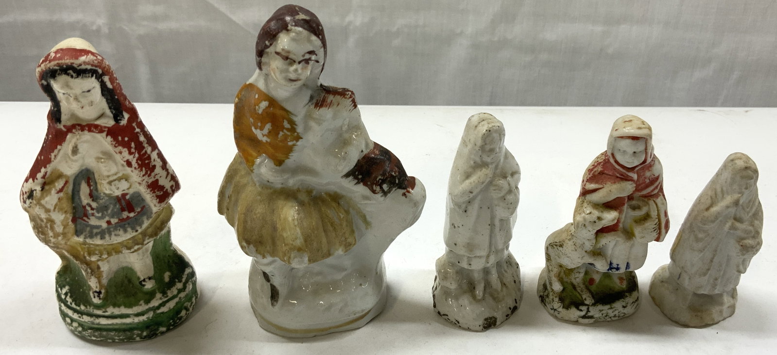 Lot 5 Antique Little Red Riding Hood Porc Figurals: Lot 5 Antique Little Red Riding Hood Porc Figurals 5 porcelain figural, each figural has visible discoloration. They are each holding a white or yellow basket, wearing a long hooded cape & dress. Incl