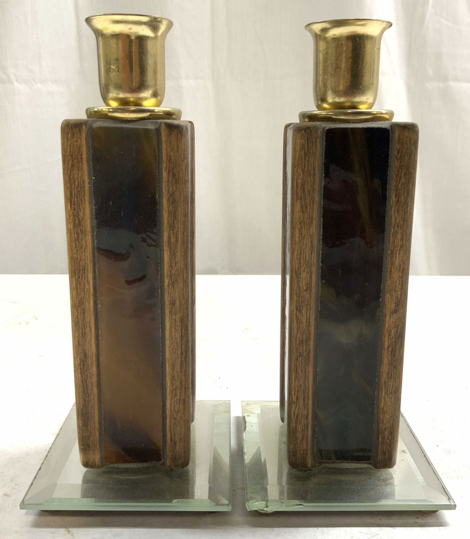 Pr Art Deco Wood Enamel & Glass Candlesticks: Lot includes 2 candlesticks. Each are wooden and enamel. Bases of candlesticks have mirrored beveled surfaces. Each candlestick has 4 feet. Tops of each piece are gold toned & metal. Each candlestick