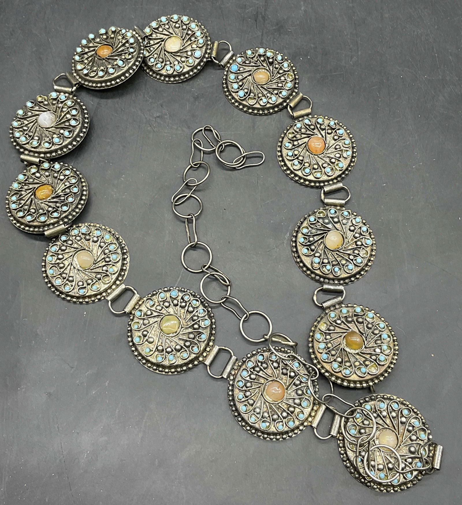 Vintage Natural Stone Cabochon Metal Belt: Vintage Natural Stone Cabochon Silver Tone Metal Belt. Various stones bezel set to the metal panels. Measures approx. 46 inches in length. Adjustable. Hook closure. Partial sticker to reverse. Surface