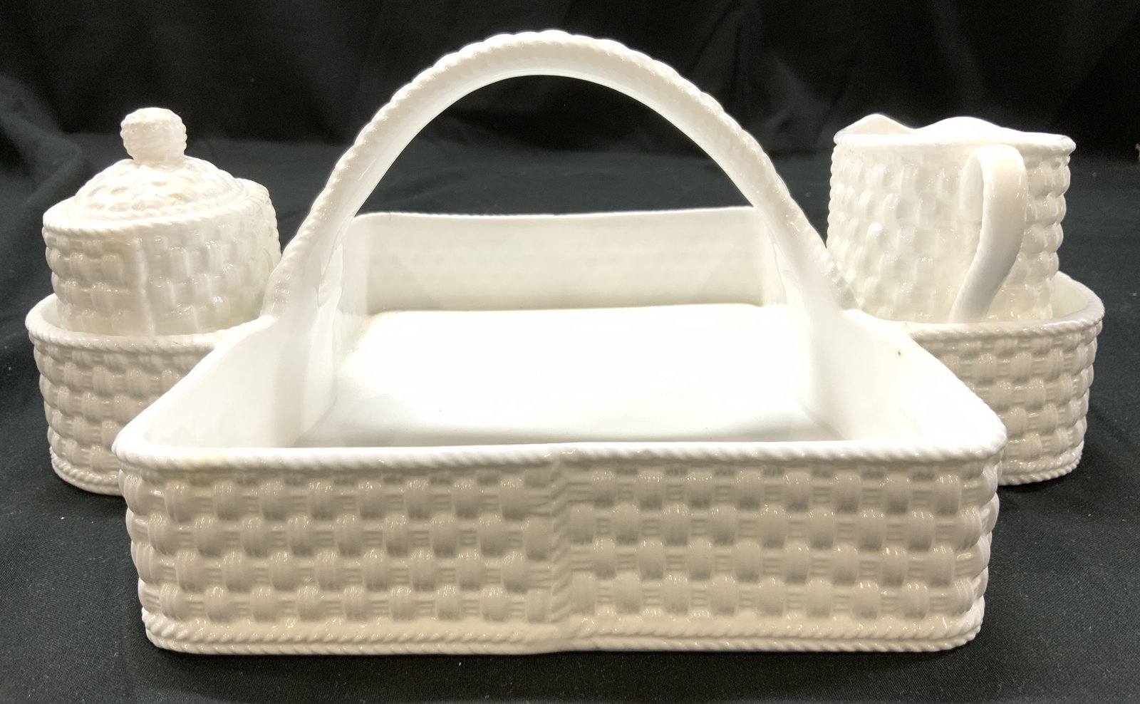 Tiffany & Co Ireland Weave Porc Strawberry Basket: Undersides are marked TIFFANY & CO TIFFANY WEAVE MADE IN IRELAND. Lot includes berry basket, creamer and sugar dish with lid. Basket has arch form handle. Each piece is white toned with woven style re