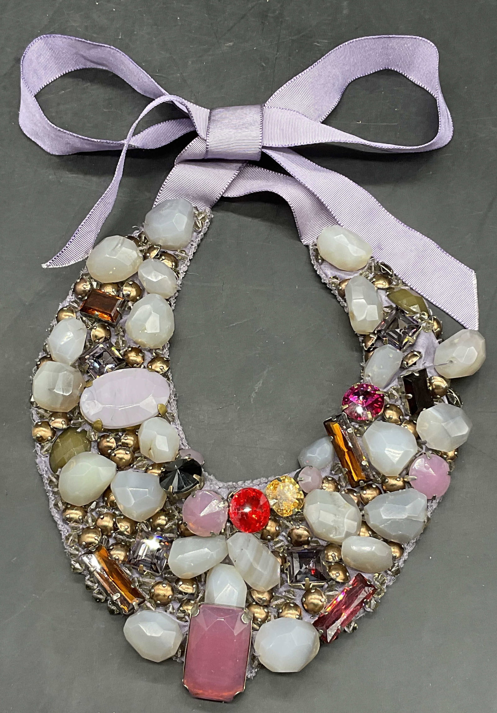 ROBERTA FREYMANN Bejeweled Fabric Bib Necklace: ROBERTA FREYMANN Bejeweled Fabric Bib Necklace. Tag to reverse reads ROBERTA FREYMANN. Necklace length measured end to end approx. 41 inches. Tie on, adjustable length. It features a variety of colorf