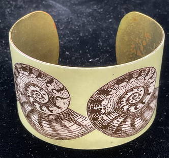 Green Nautilus Shell Cuff Bracelet: Gold tone green nautilus shell motif cuff bracelet. Measures approx 2.25 inches wide, band approx 1.5 inches wide. Some wear including scratching observed. Jewelry, estate jewelry, costume