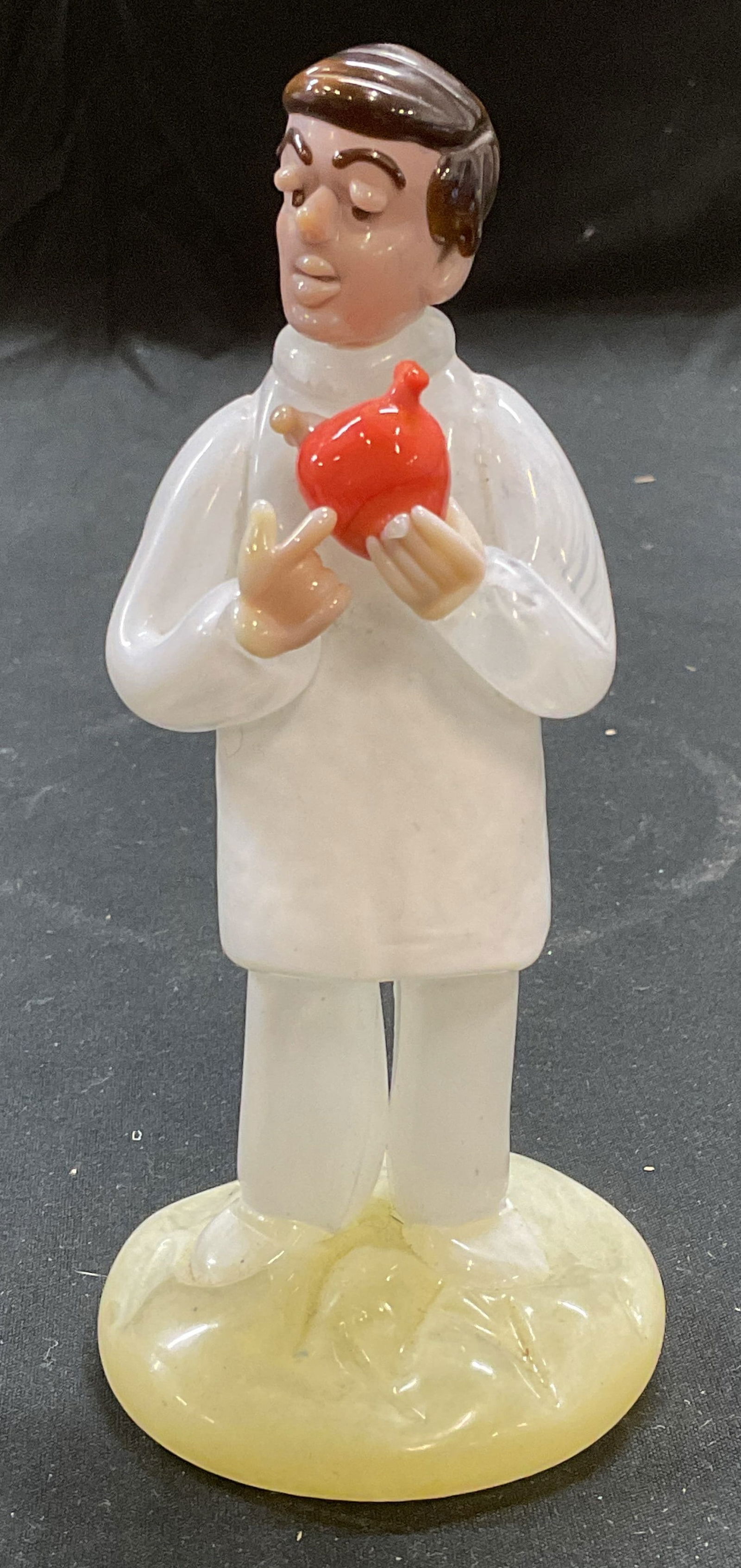 A & A Bohemian Crystal Doctor Figurine: A & A bohemian crystal figurine. Doctor figural holding heart. Hand blown crystal. Signed on underside. Measures approx 2.25 x 5.25 inches. Some wear including scratching. A and a crystal figurine, do