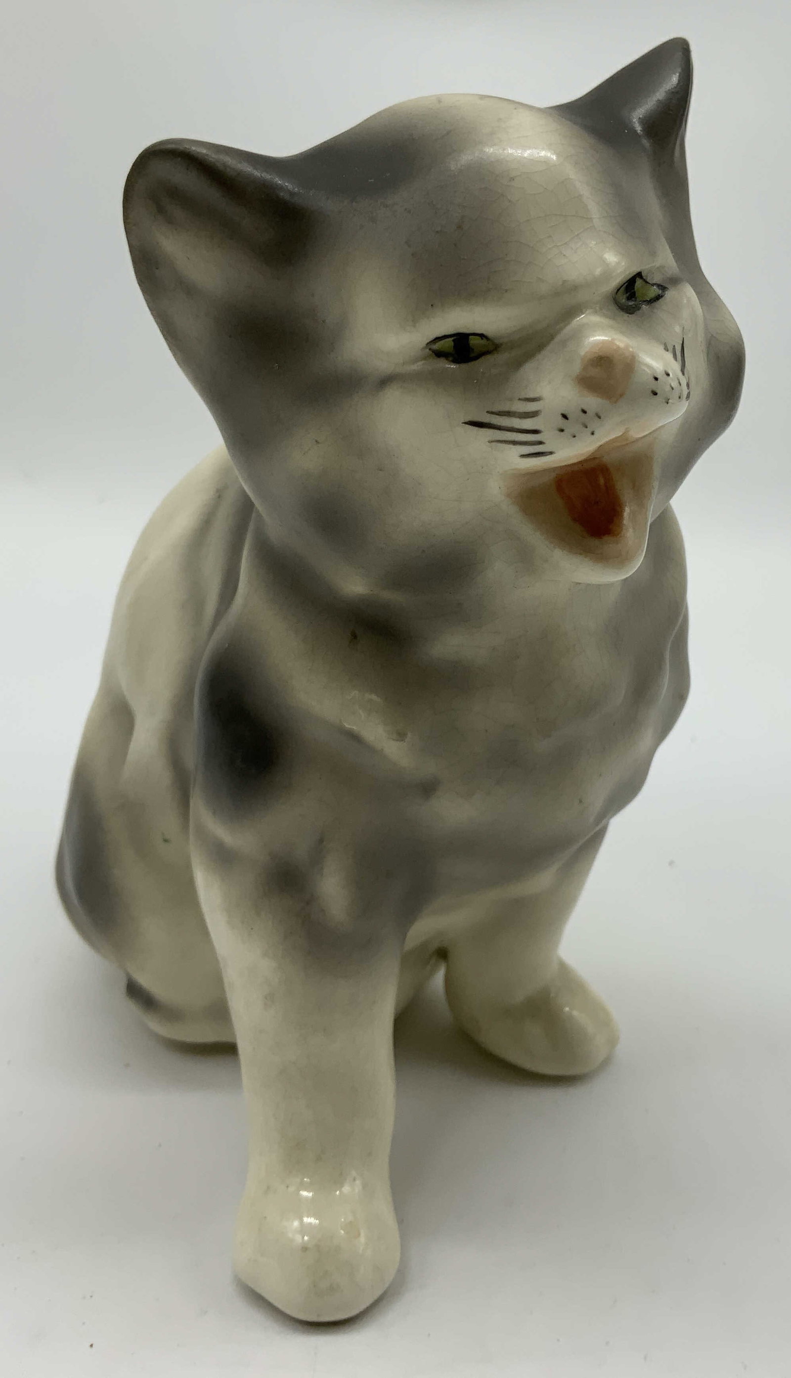 Coventry Scaredy Cat Porcelain Figural: Coventry Scaredy Cat Porcelain Figural Porcelain cat figural depicted with an open mouth & giving a scaredy cat look. Signed & marked. Surface wear consistent to age, use & exposure. Visible crazing, 