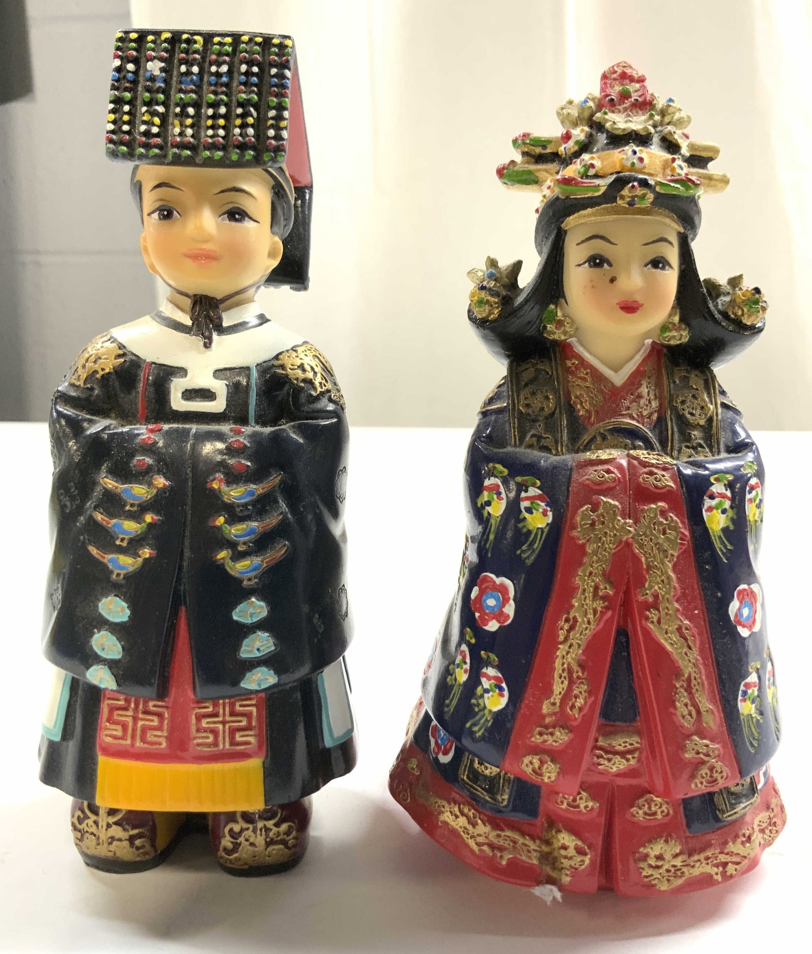 Lot 2 Korean Traditional Resin Royalty Figure: Lot includes 1 male and 1 female figure (prince & princess). Each piece appears to be resin. Figures each dressed in Korean traditional attire. Undersides appear to be trademarked illegibly. Possibly 