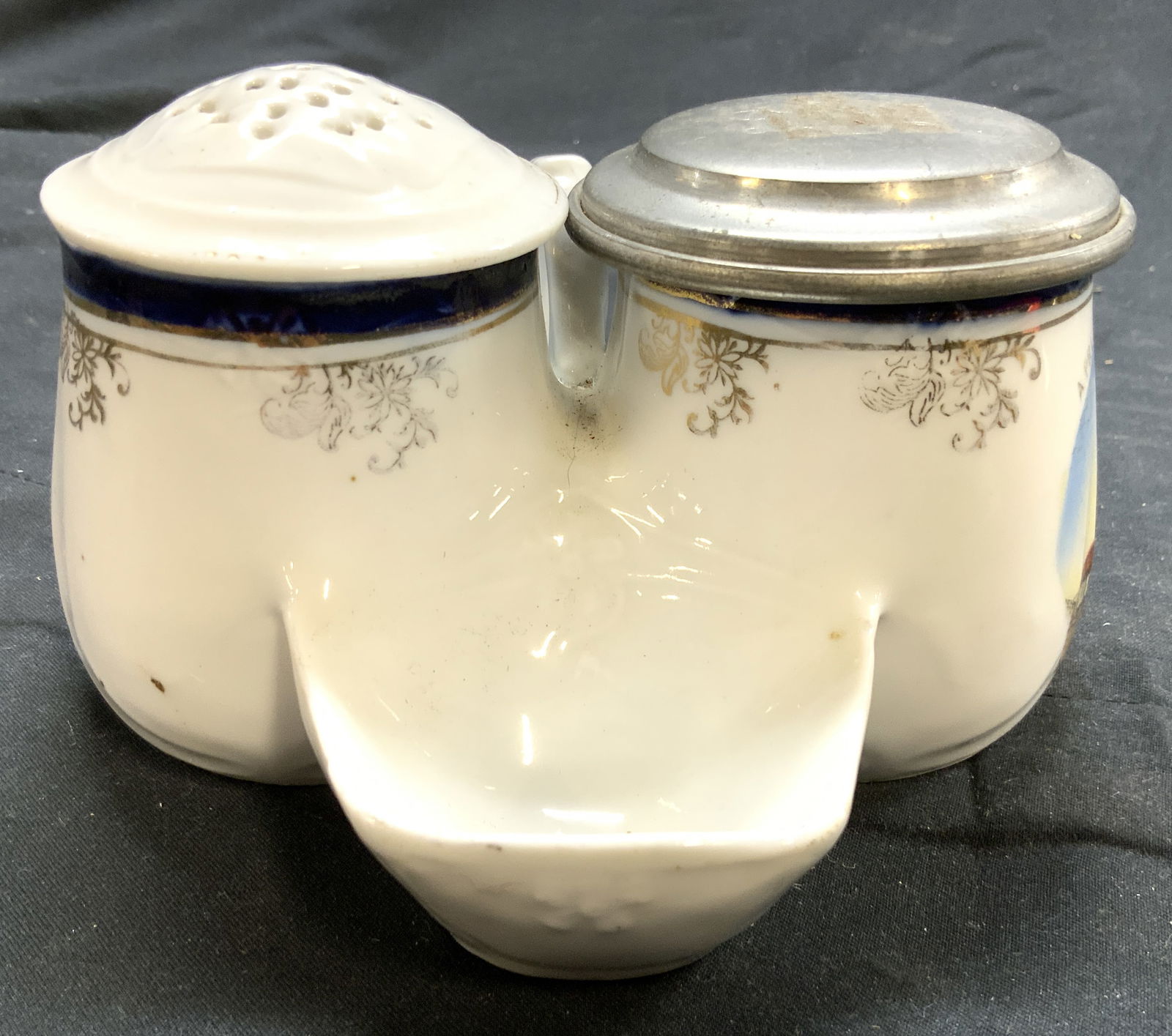 Vintage Porcelain Salt & Pepper Shakers W Holder: Lot includes 1 salt & 1 pepper shaker & 1 holder. Each piece is porcelain. Holder has handle and basin. One side has image of TROWBRIDGE PARISH CHURCH. Piece includes 1 silver toned pewter lid monogra