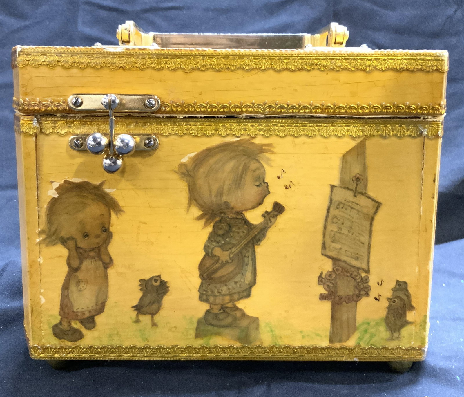 Decoupage Vtg Wooden Purse Box W Lid: Purse box is vintage & appears to be wooden. Piece has decoupage detail with singing child figures. Purse box is yellow & gold toned. Piece has lid with handle. Purse box measures approximately 8.5 in