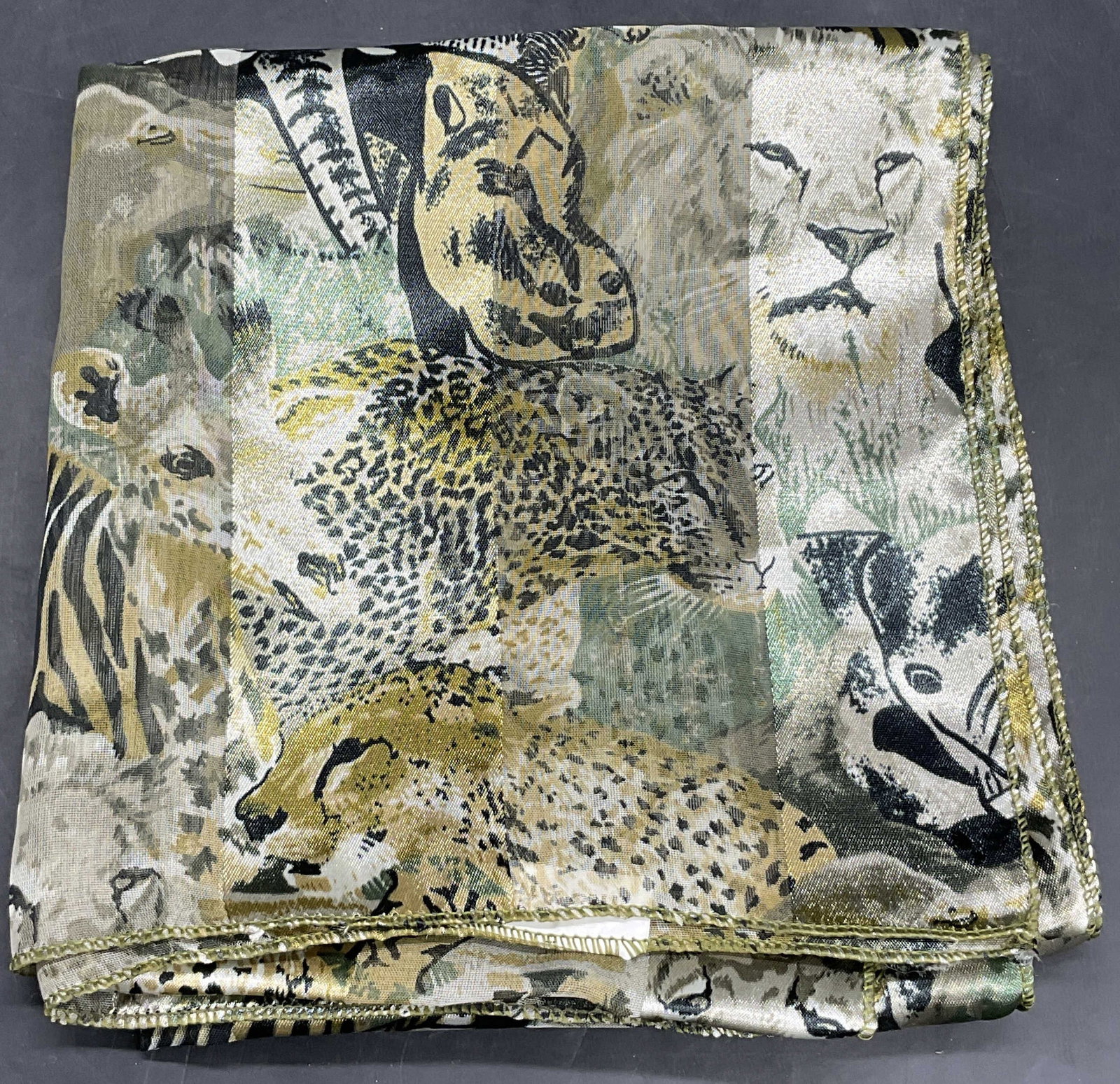 INTO AFRICA Animal Motif Scarf: INTO AFRICA Animal Motif Scarf. Features zebras, elephants, cheetahs, lions, and other African animals. Crafted from soft hand material. Tag attached reads INTO AFRICA. Measures approx. 59W x 13L in. 