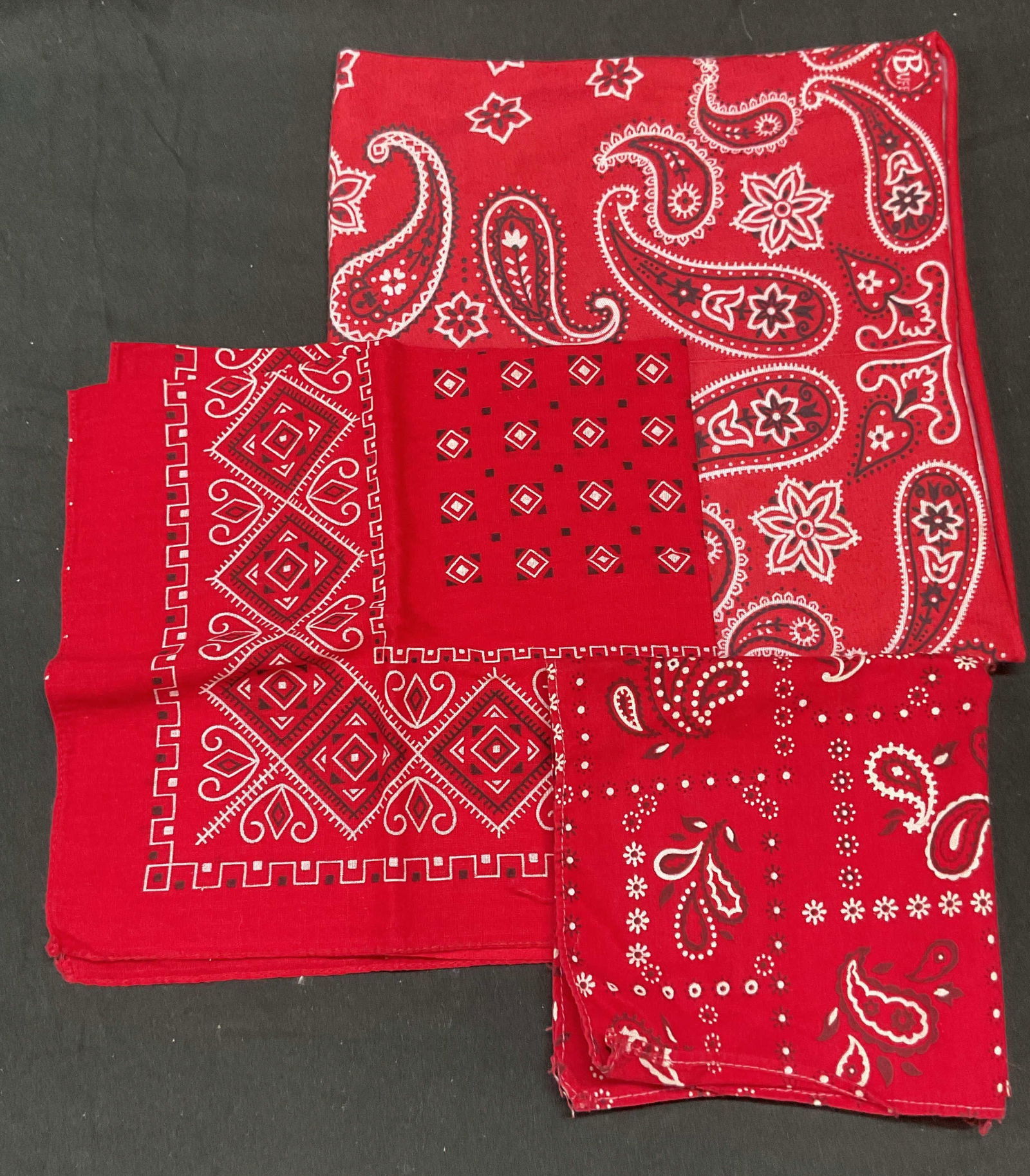 Lot 3 Red Cotton Paisley Bandanas, Accessories: Lot of 3 red cotton paisley and geometric print bandanas and accessories. Largest piece measures approx 16 x 16 inches. All piece have wear including rubbing and blemishes. Red bandana, paisley bandan