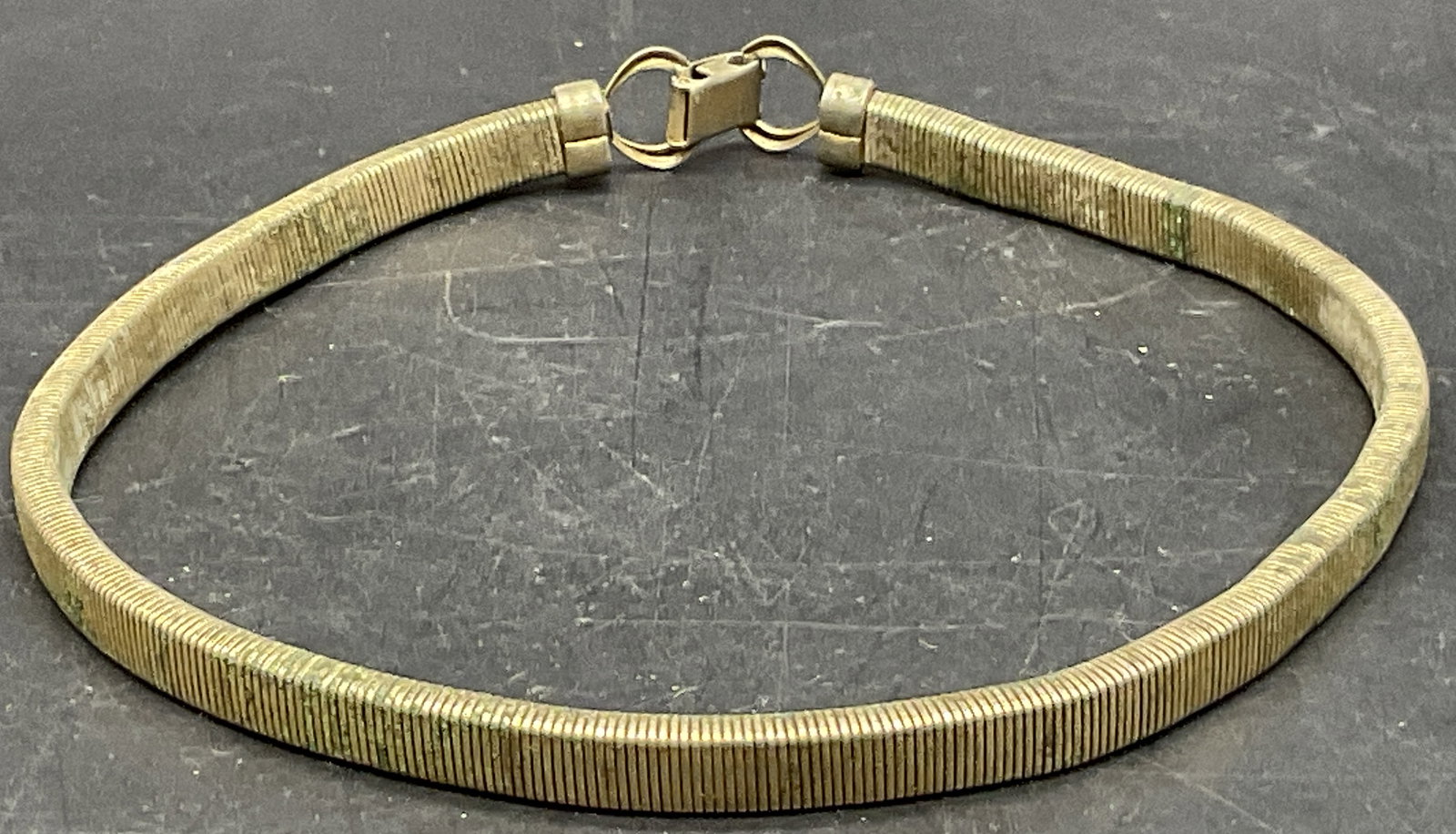 Vintage Tubogas Style Gold Tone Metal Necklace: Vintage Tubogas Style Gold Tone Metal Choker Necklace. Metal clasp closure secures the piece. Necklace length measured end to end approx. 14.75 inches. Discoloration, residue, and surface wear present