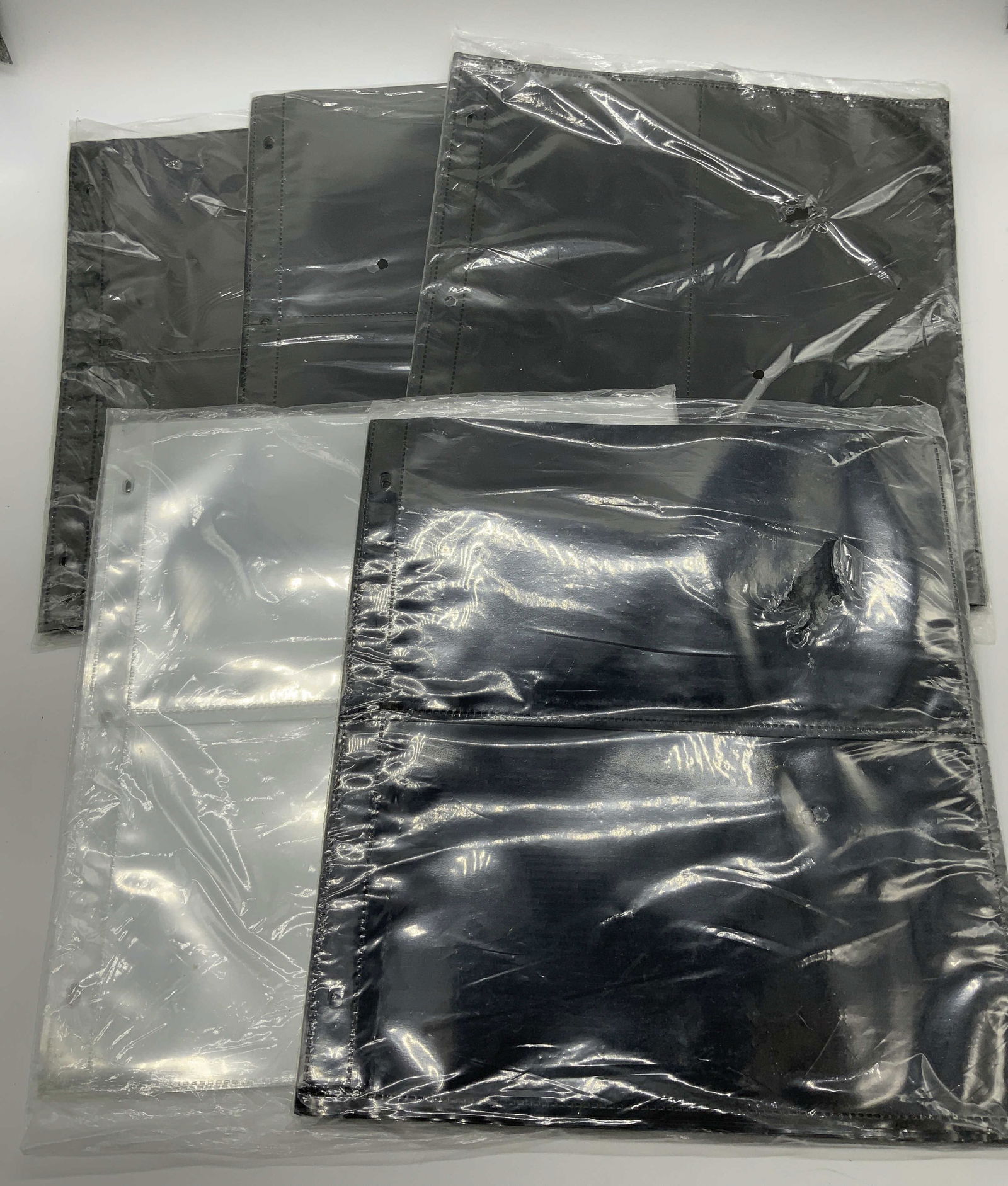 20+ Double Sided Trading Card Sleeves & Sheets NIP: 20+ Double Sided Trading Card Sleeves & Sheets NIP Black & clear double sided sleeves & sheets. NEW IN PLASTIC. Surface wear consistent to age, use & exposure. Measurements: length 11.3in x width 10.8