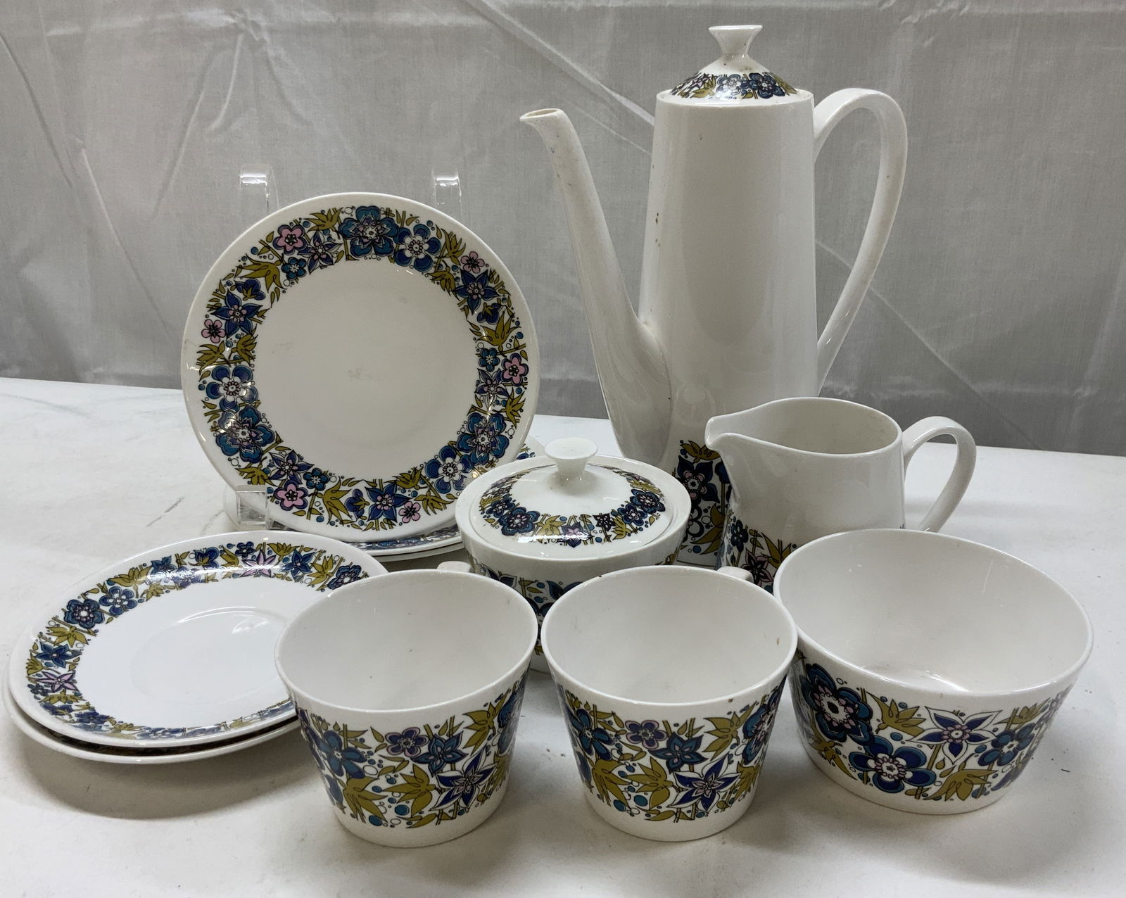 ROYAL TUSCAN Nocturne Bone China Tea Set ENGLAND: ROYAL TUSCAN Nocturne Bone China Tea Set ENGLAND 3 porcelain small plates, 2 saucer plates, sugar bowl w lid, small bowl, 2 cups, 1 creamer & 1 teapot. Each piece has a floral border in white, blue, b