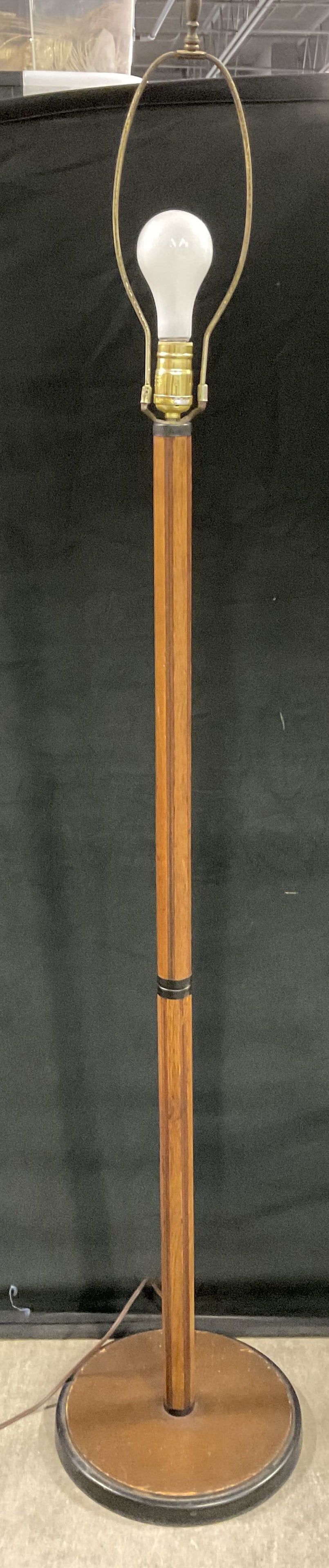 Vintage Wooden Floor Lamp: Vintage Wooden Floor Lamp. Crafted from wood and metal materials. Corded. Measures approx. 58H x 10.5W in. Measurement includes metal harp. Not tested for function. Chipping, discoloration, wobble to 